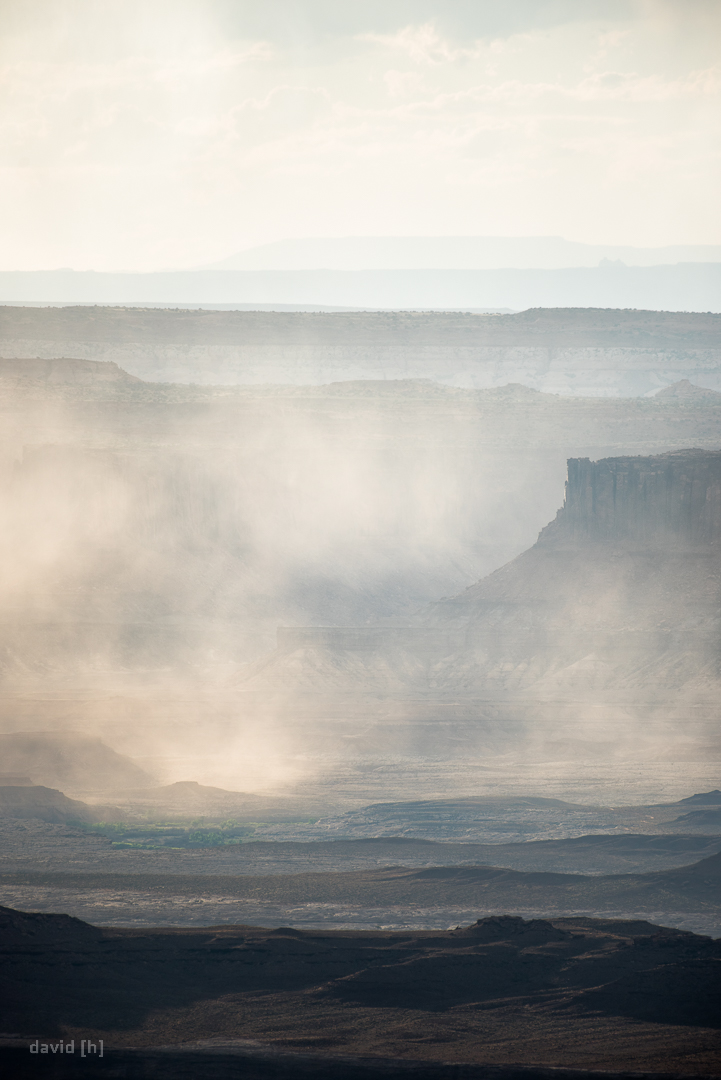 The sun paints a stunning image by illuminating the rain in the canyons of Canyonlands.