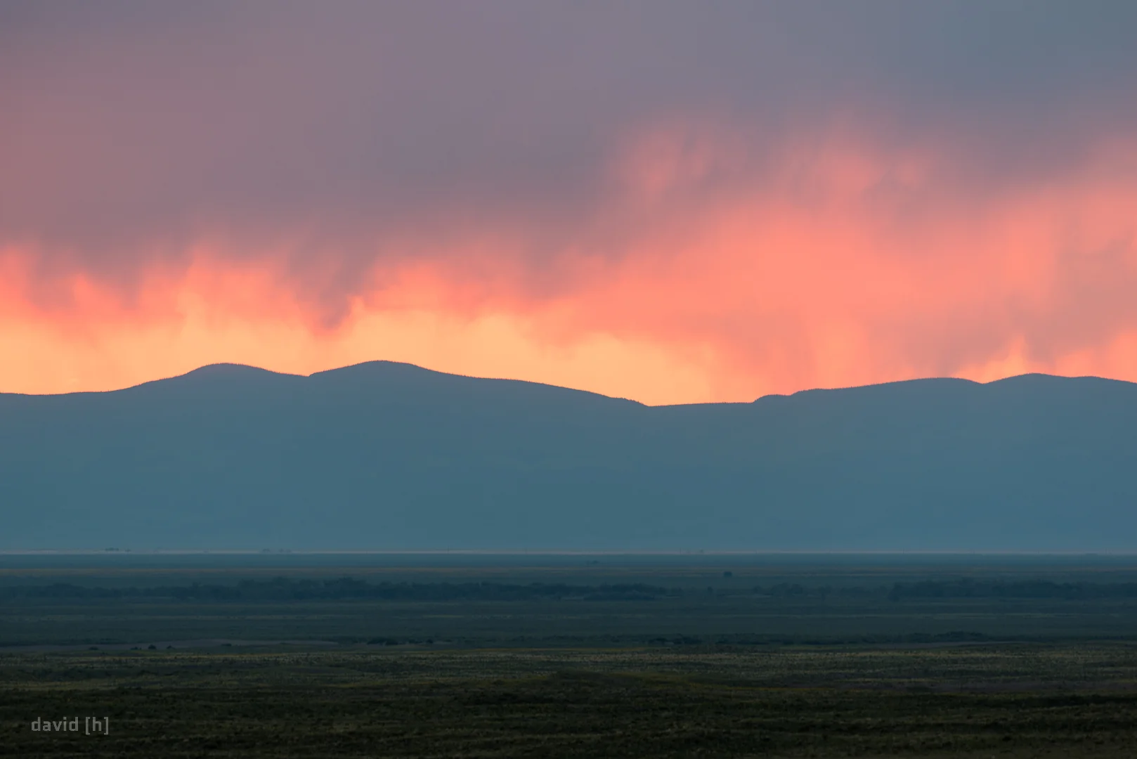 Stunning display of colour through the rainy clouds during sunset at Great Sand Dunes National Park.