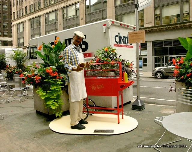 "Hot-Dog" Celebrating the Familiar with a classic hot dog cart, plastic ketchup and mustard bottles, and an old-school apron-clad vendor. Courtesy of Untappedcities.com and afinelyne.com/