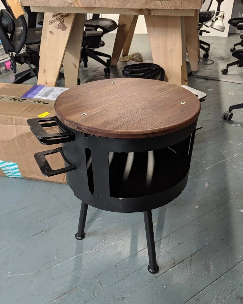 The top of the grill here is covered for travel with the custom cutting board