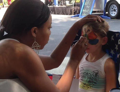 2nd Sundays July 2014 photo of Charlotte Masengale getting face Painting Susan Robertson photo.jpg