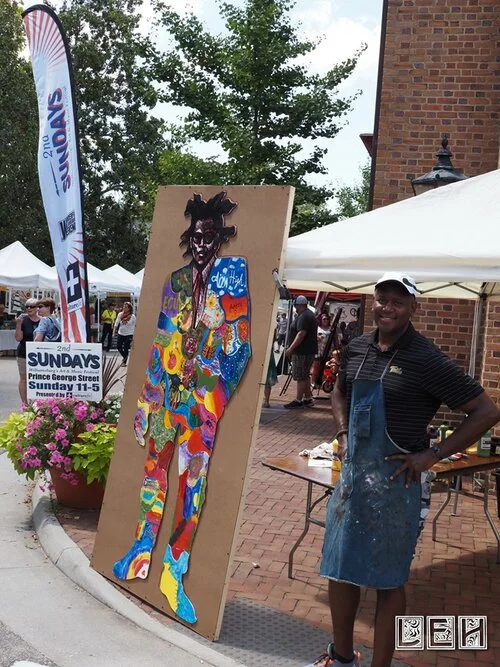 Steve Prince with 1 completed Art project August 2019 with 2nd Sundays Street sign & banner in photo.jpg