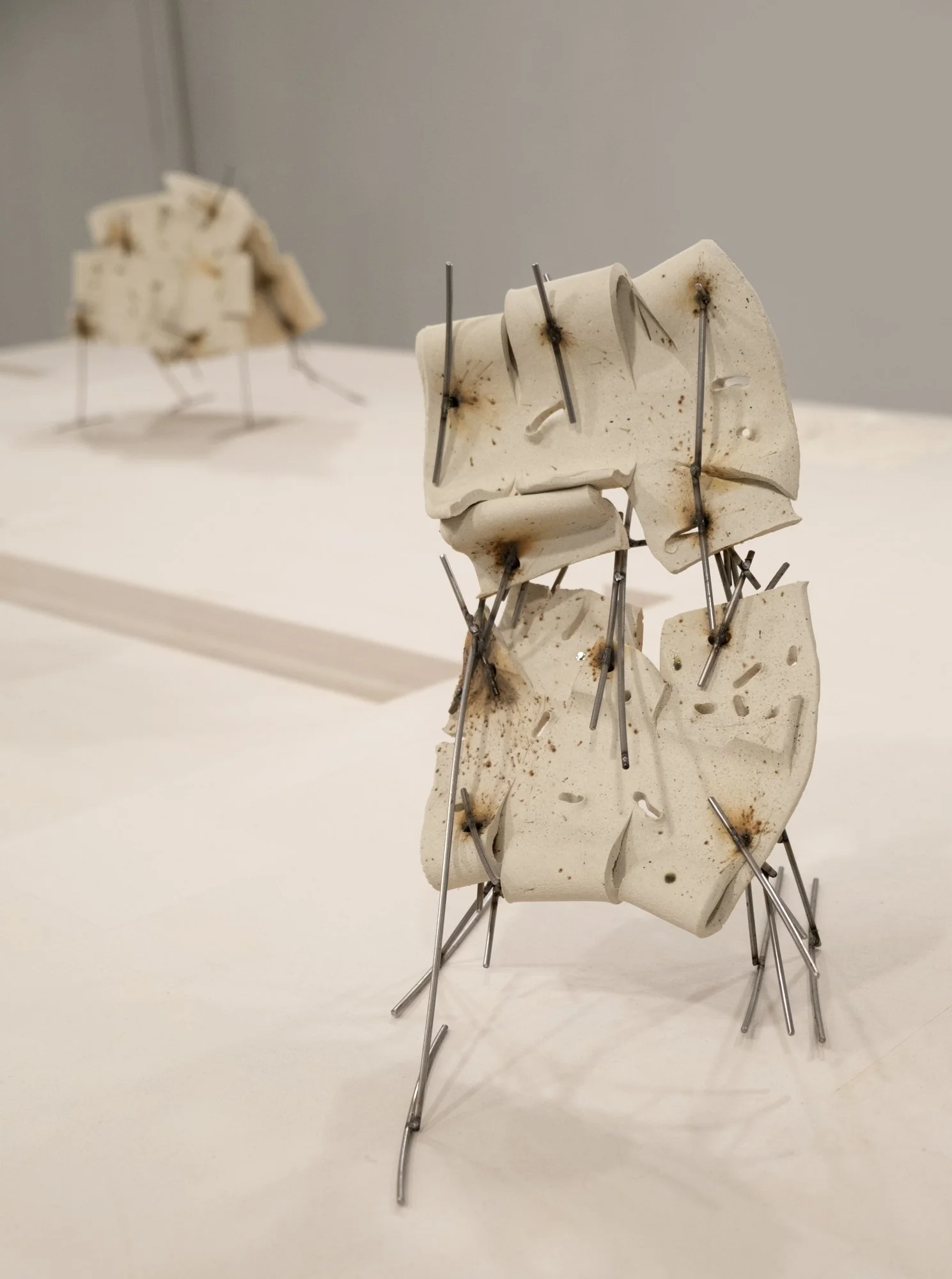   Dancers 7 , 2025, ceramic with glaze details and welded steel, 14h x 8 x 12in   Courtyard , 2026, Site-Service, Nine, New York 