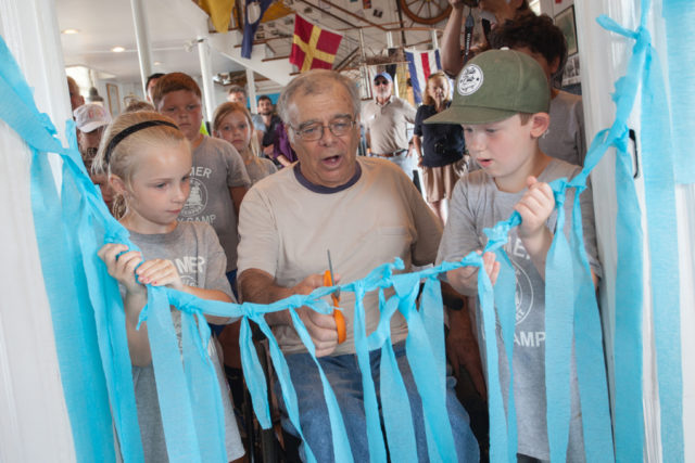 Bob Jester cuts the ribbon at the opening ceremony for Captain Bob's Quarterdeck. Photo: Katharine Schroeder