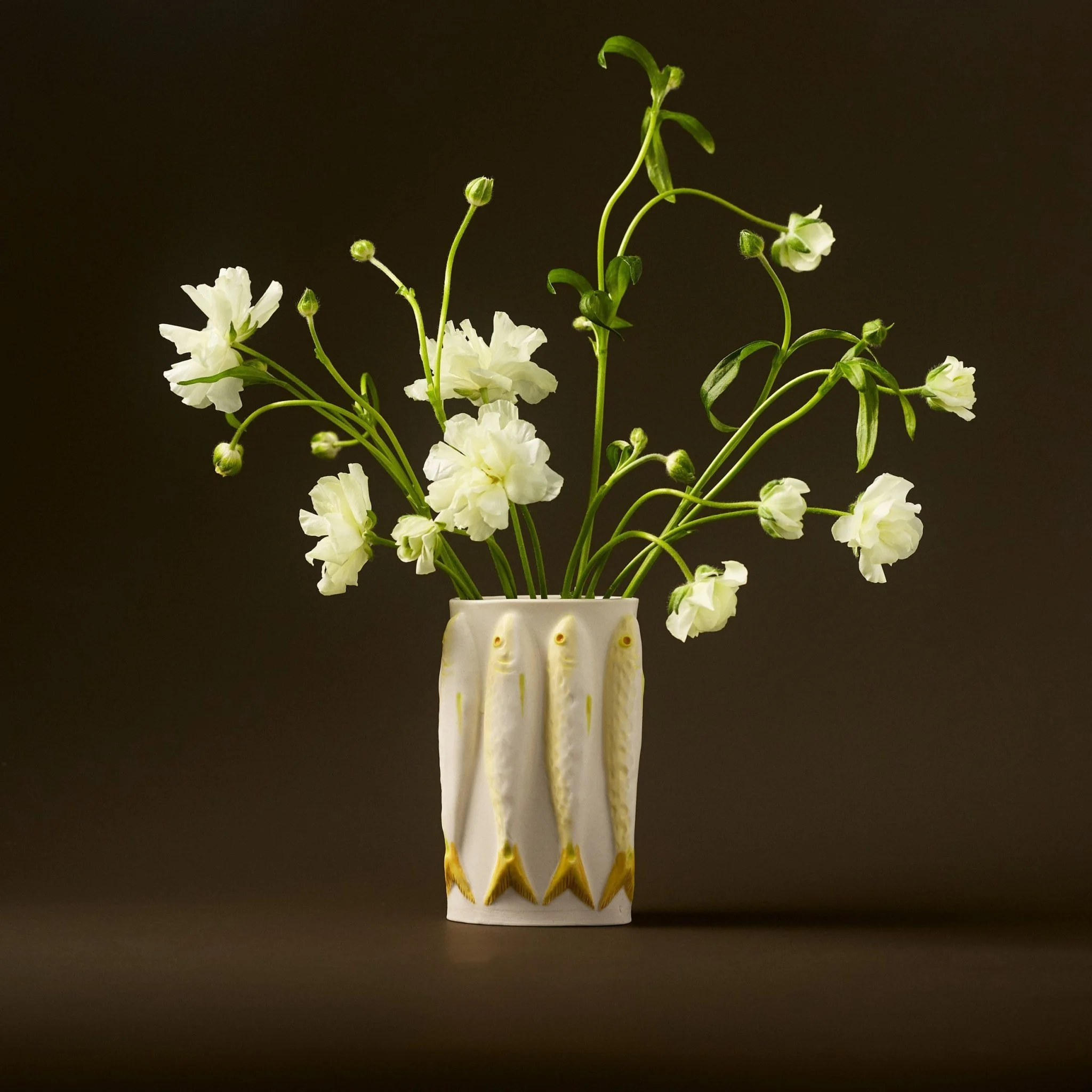 PetitFelts Moonflower ceramic vase with flowers on a brown background