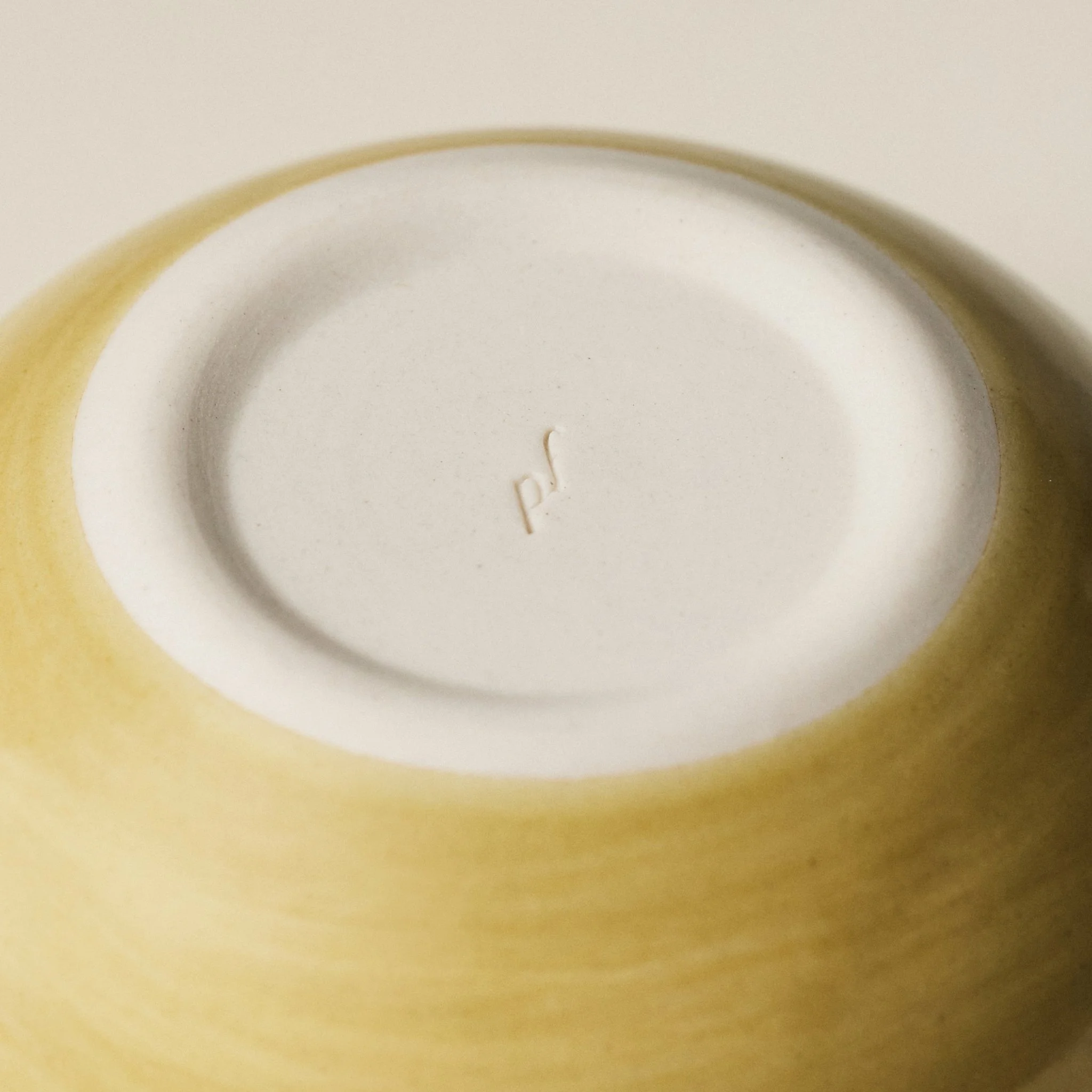 Underside detail of the PetitFelts Fennel small ceramic bowl showing the maker's mark