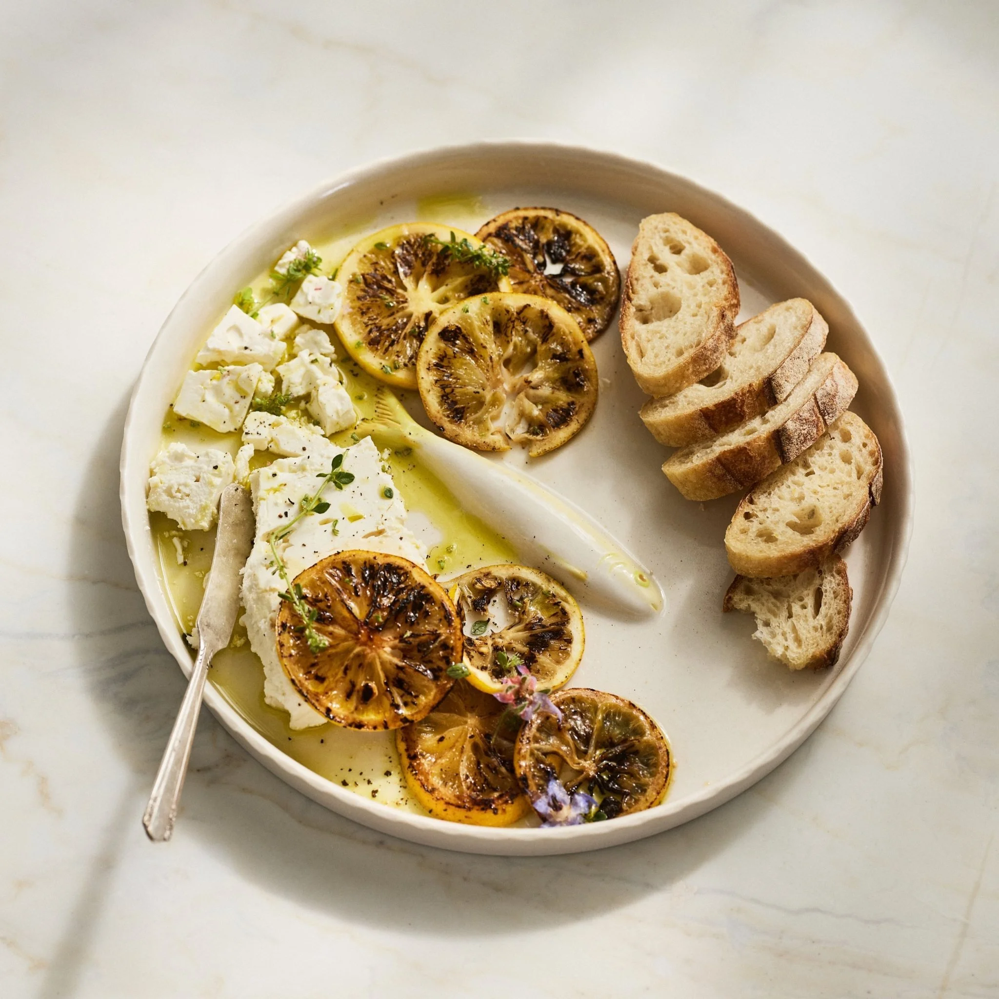 PetitFelts Big Julian Moonflower ceramic tray styled with grilled citrus, feta cheese and bread