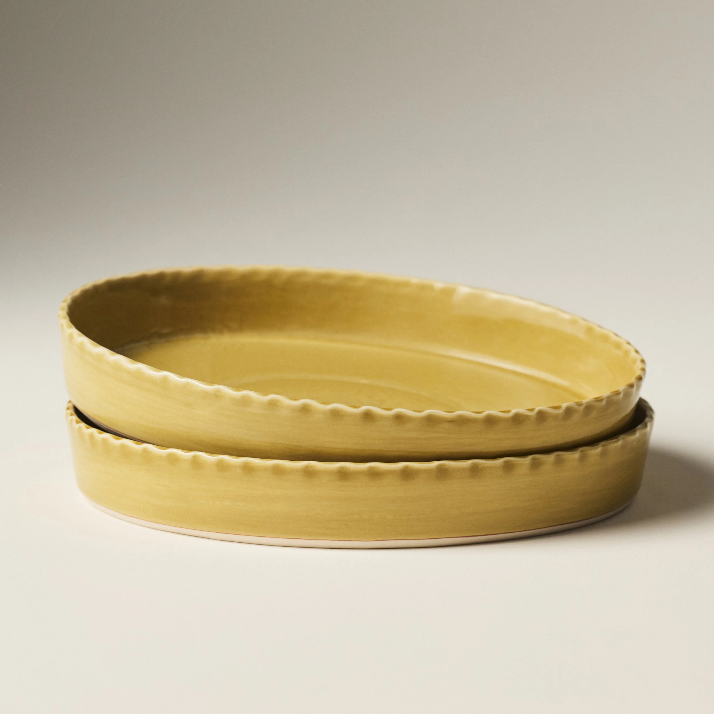 PetitFelts Fennel ceramic platters stacked, showing rim detail and depth