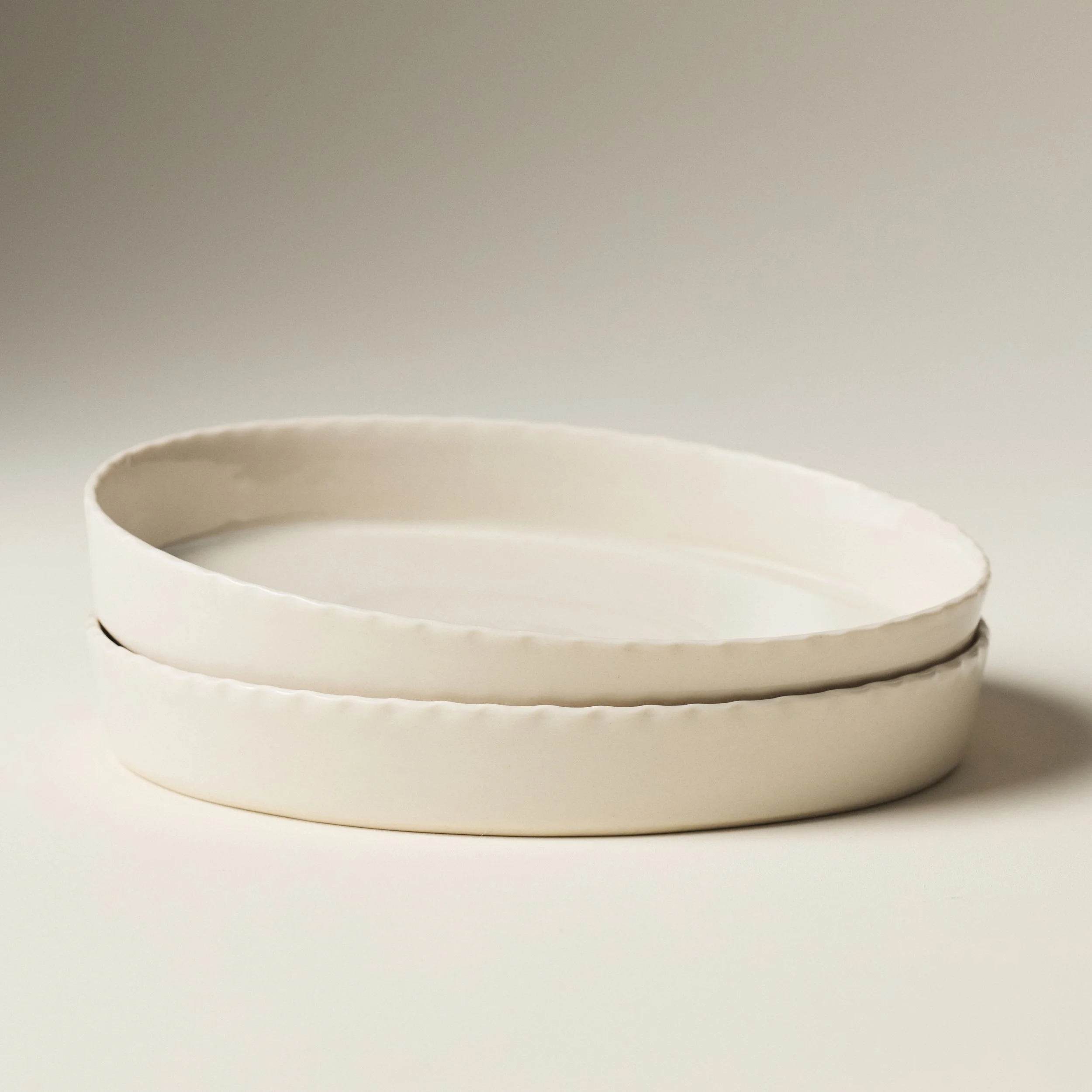 etitFelts Natural ceramic platters stacked, showing rim detail and depth