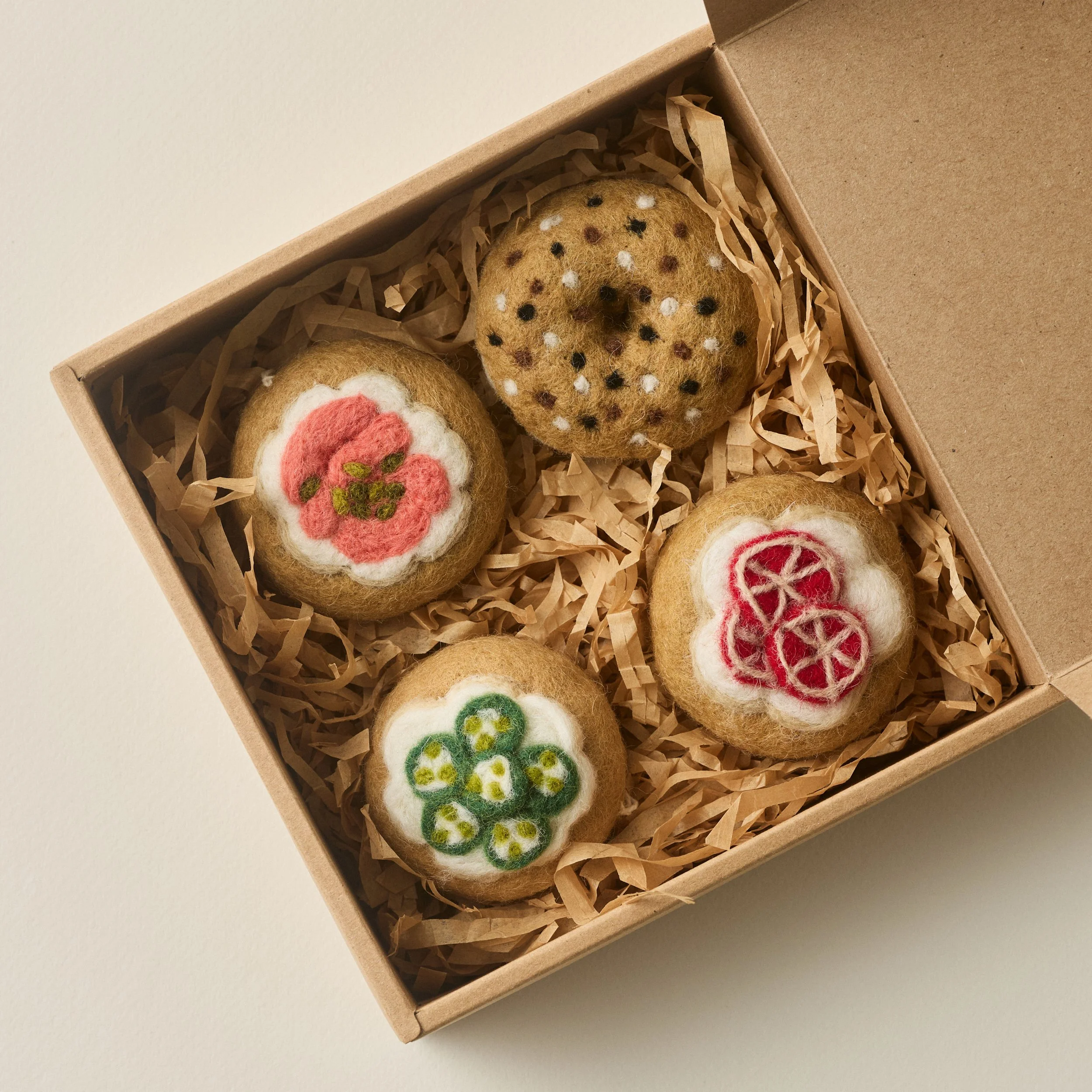 PetitFelts bagle ornament set with lid to box open revealing the bagel ornaments inside