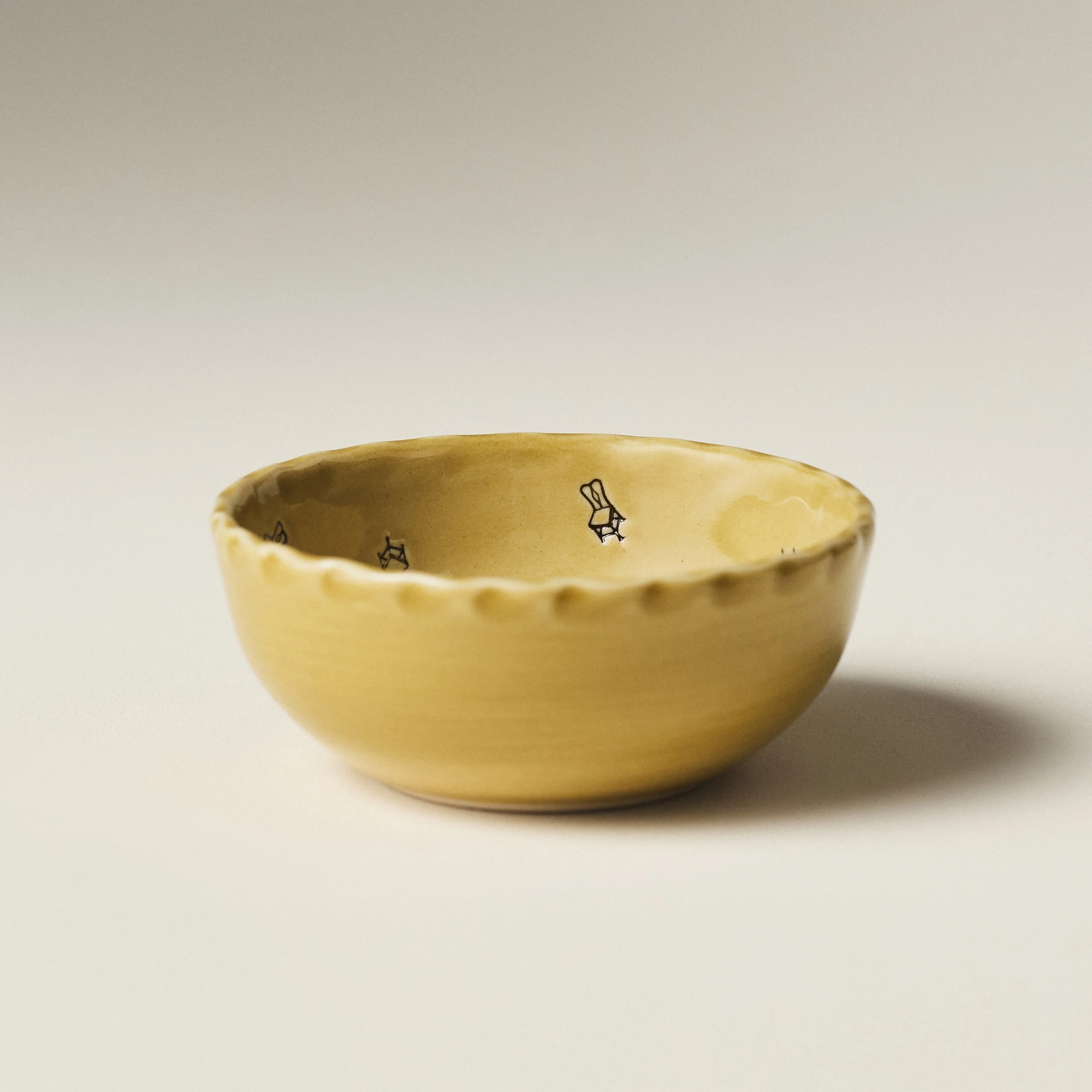 Front view of the PetitFelts Petite Bowl in Fennel glaze showing its scalloped rim