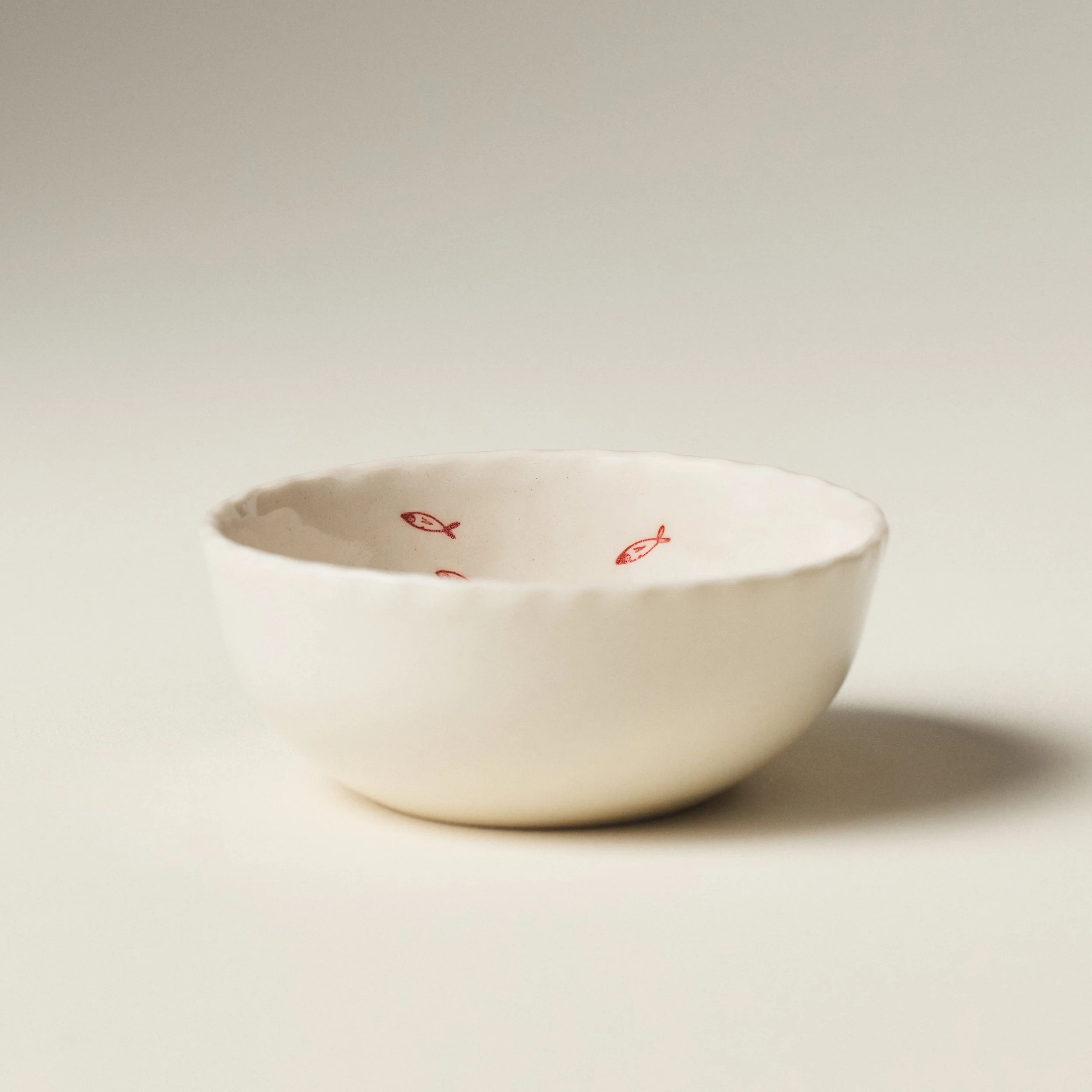 Front view of the PetitFelts Petite Bowl sardine stamp in Natural glaze showing its scalloped rim
