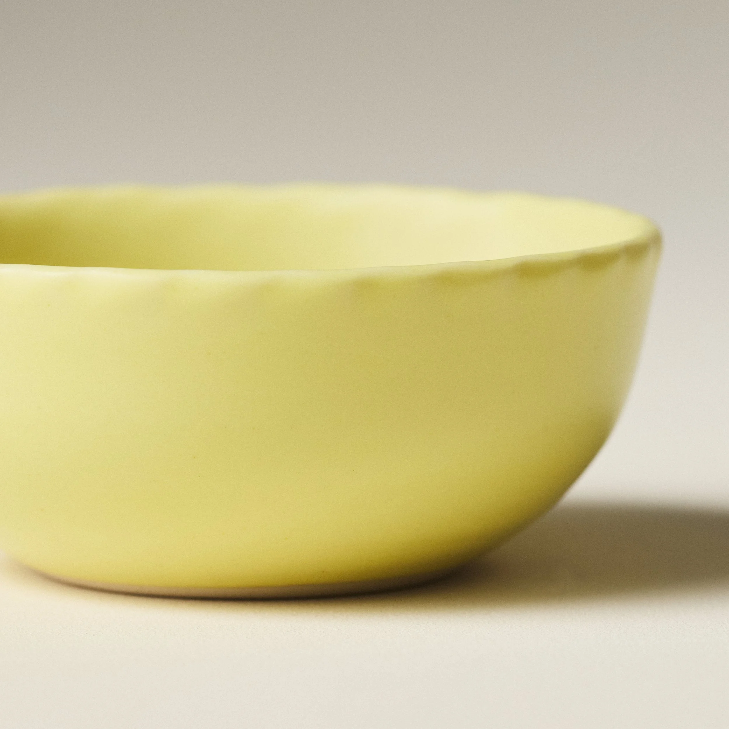 Front view of the PetitFelts Custard small ceramic bowl showing its fluted rim