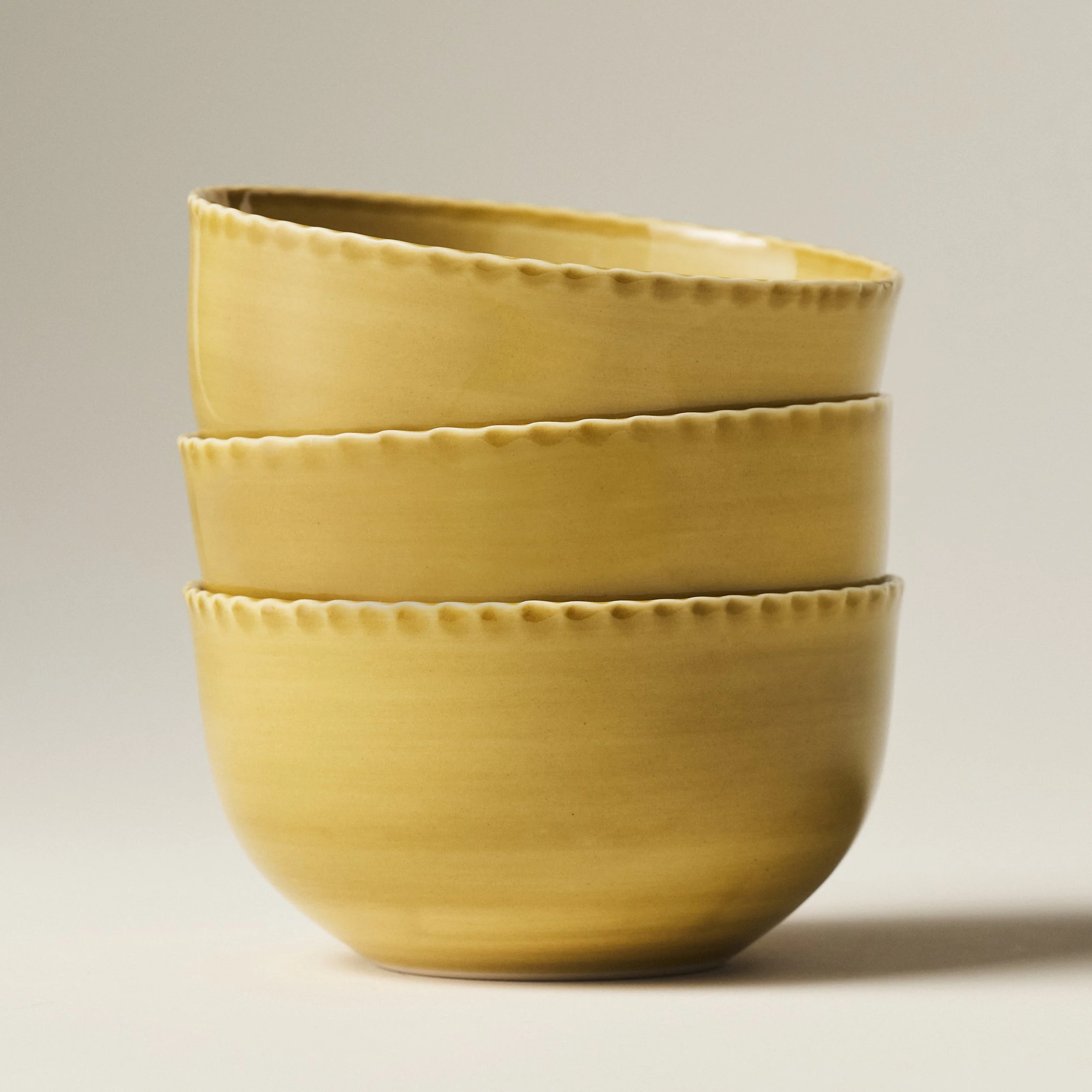 PetitFelts Fennel yellow ceramic dinner bowls stacked, showing rim detail and depth