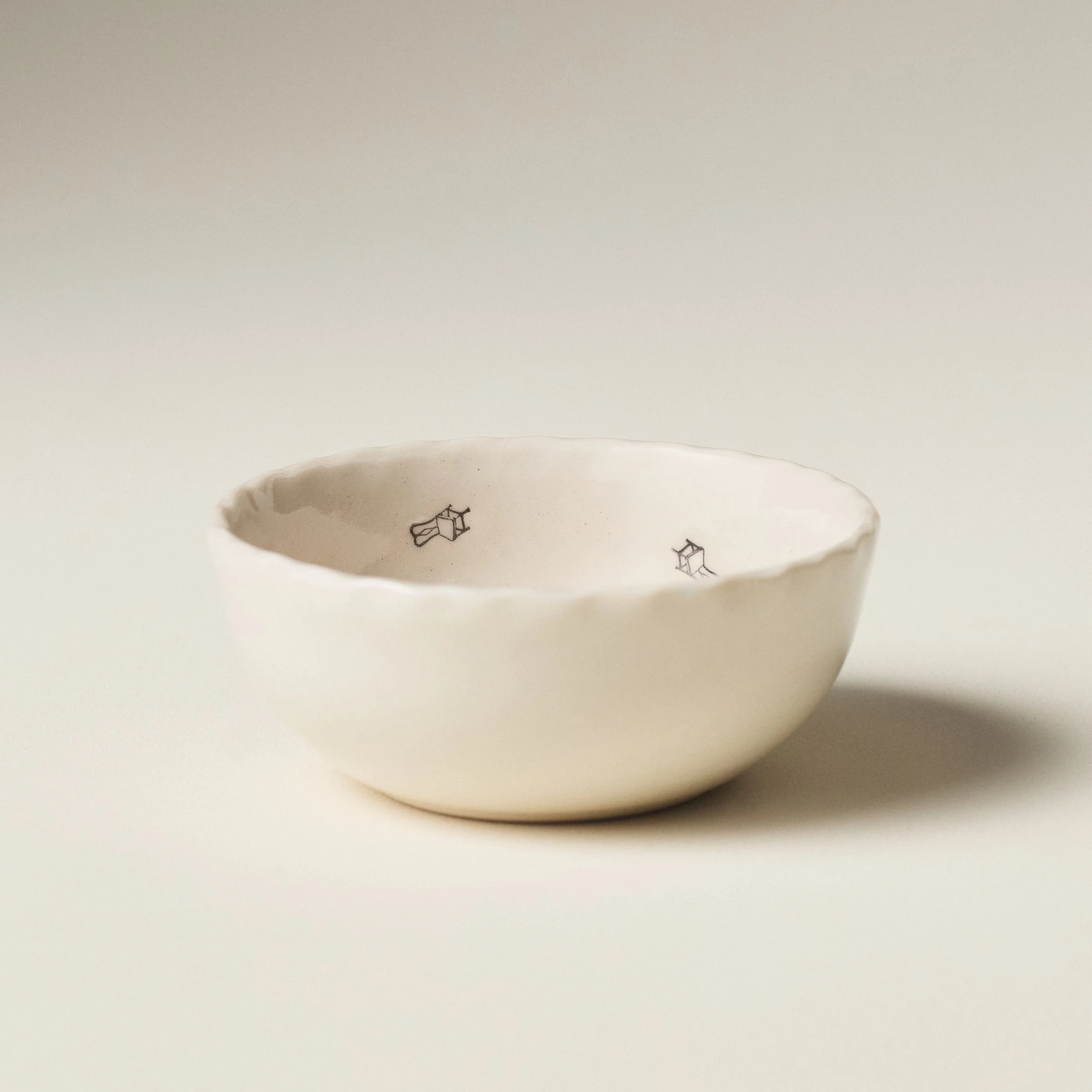Front view of the PetitFelts Petite Bowl chair stamp in Natural glaze showing its scalloped rim