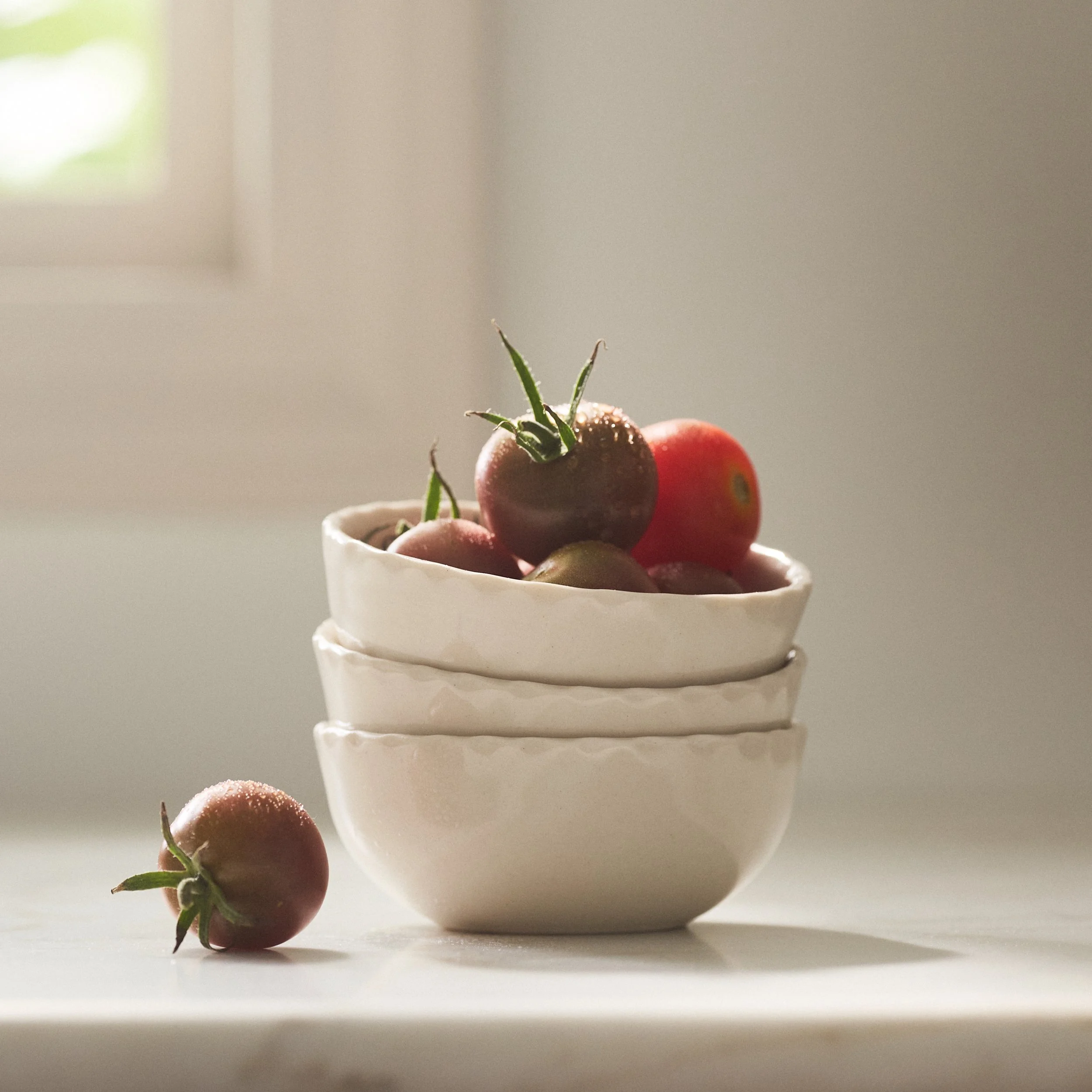 PetitFelts Natural small ceramic bowls stacked, styled with cherry tomatoes