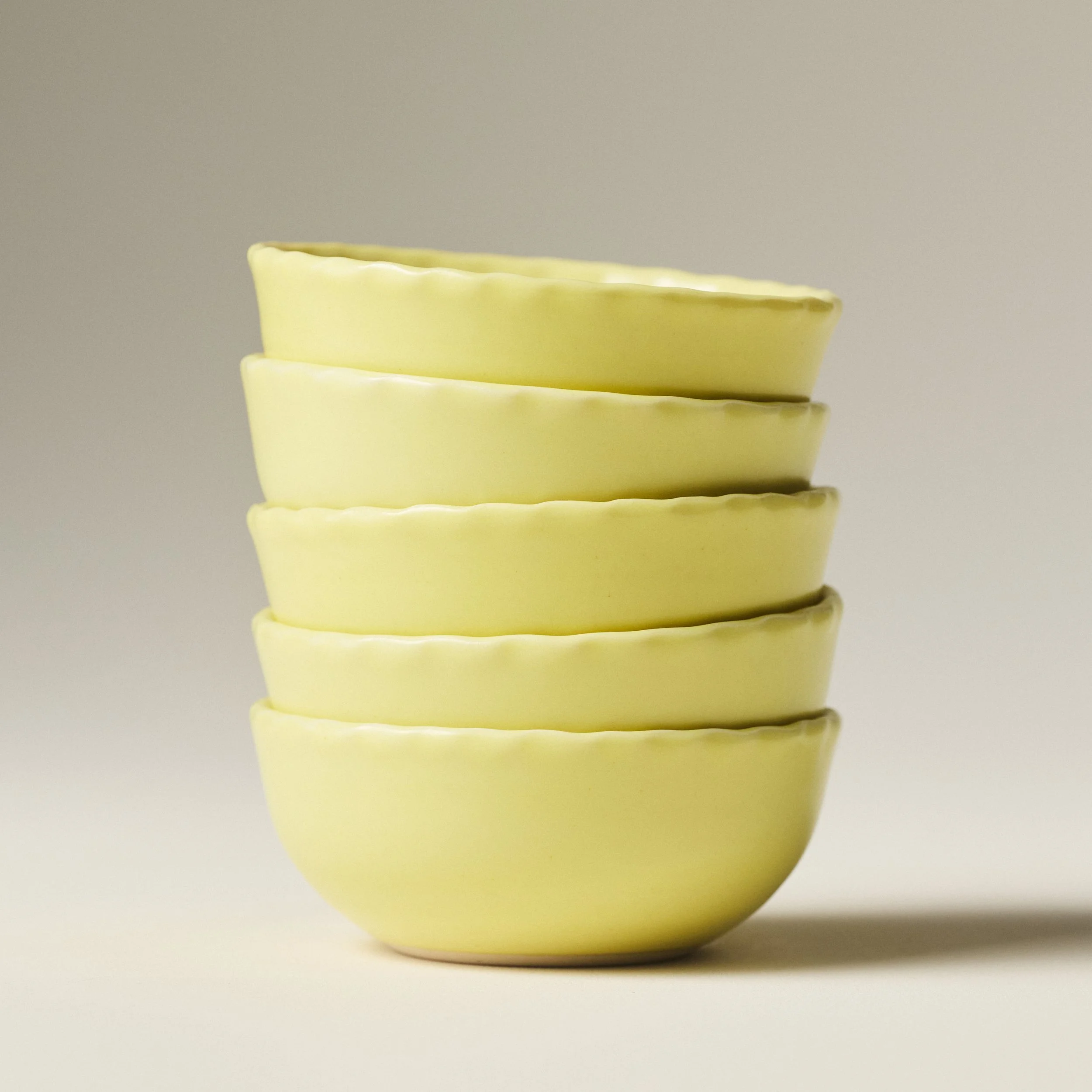 PetitFelts Custard yellow ceramic bowls stacked, showing rim detail and depth