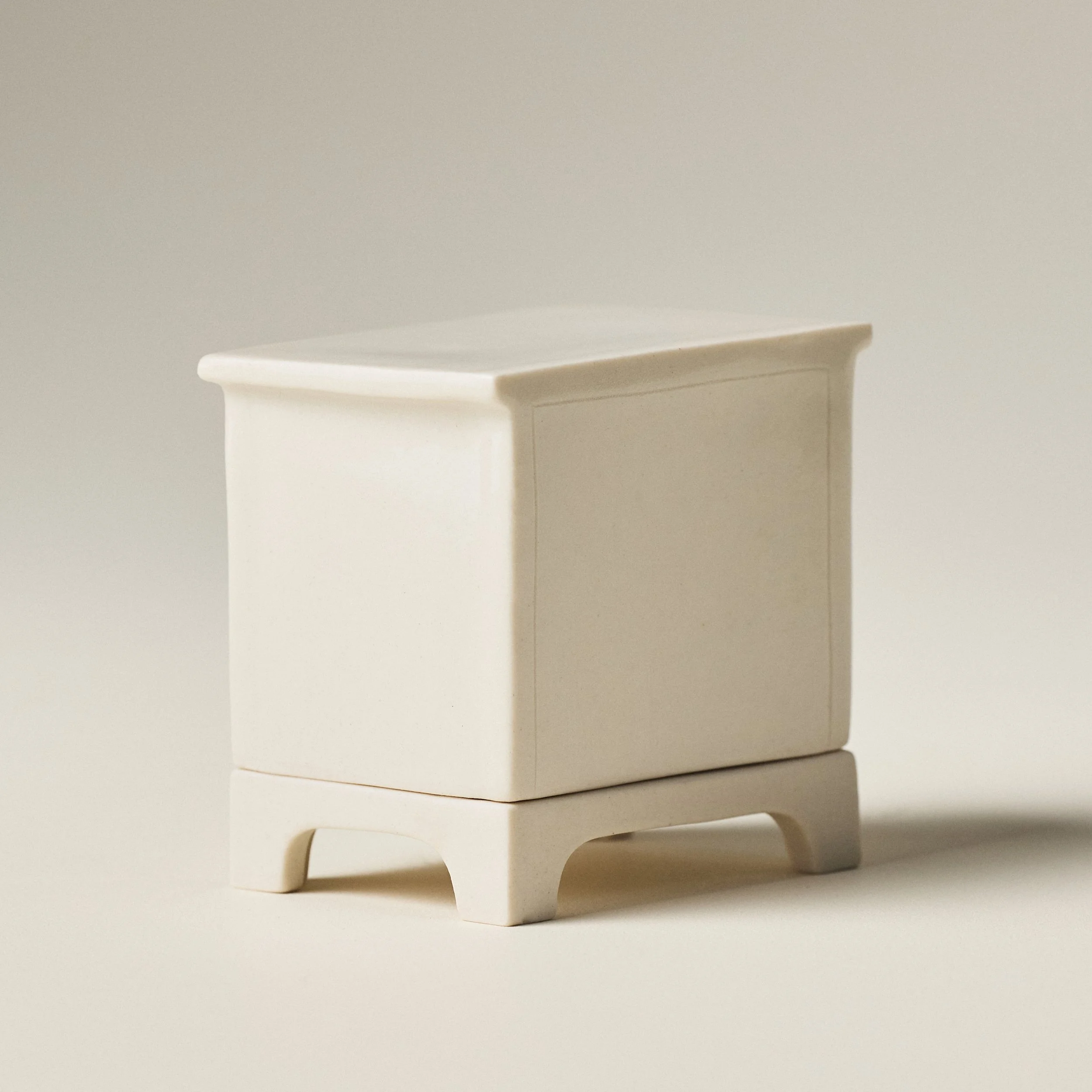 Side and back  profile of hand-glazed ceramic match striker showing lid and base