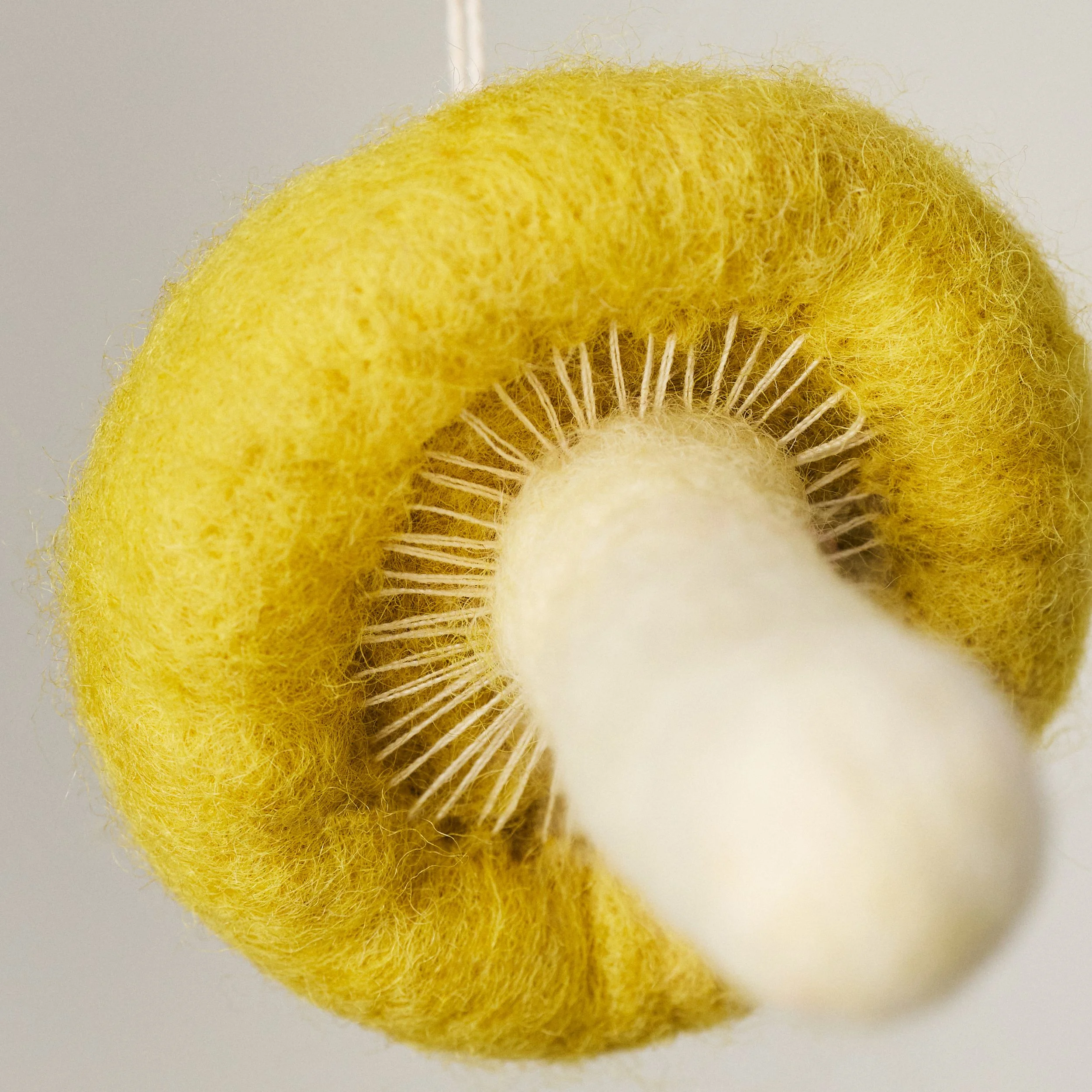Bolete needle felted mushroom ornament. Bottom detail view showing the gills.