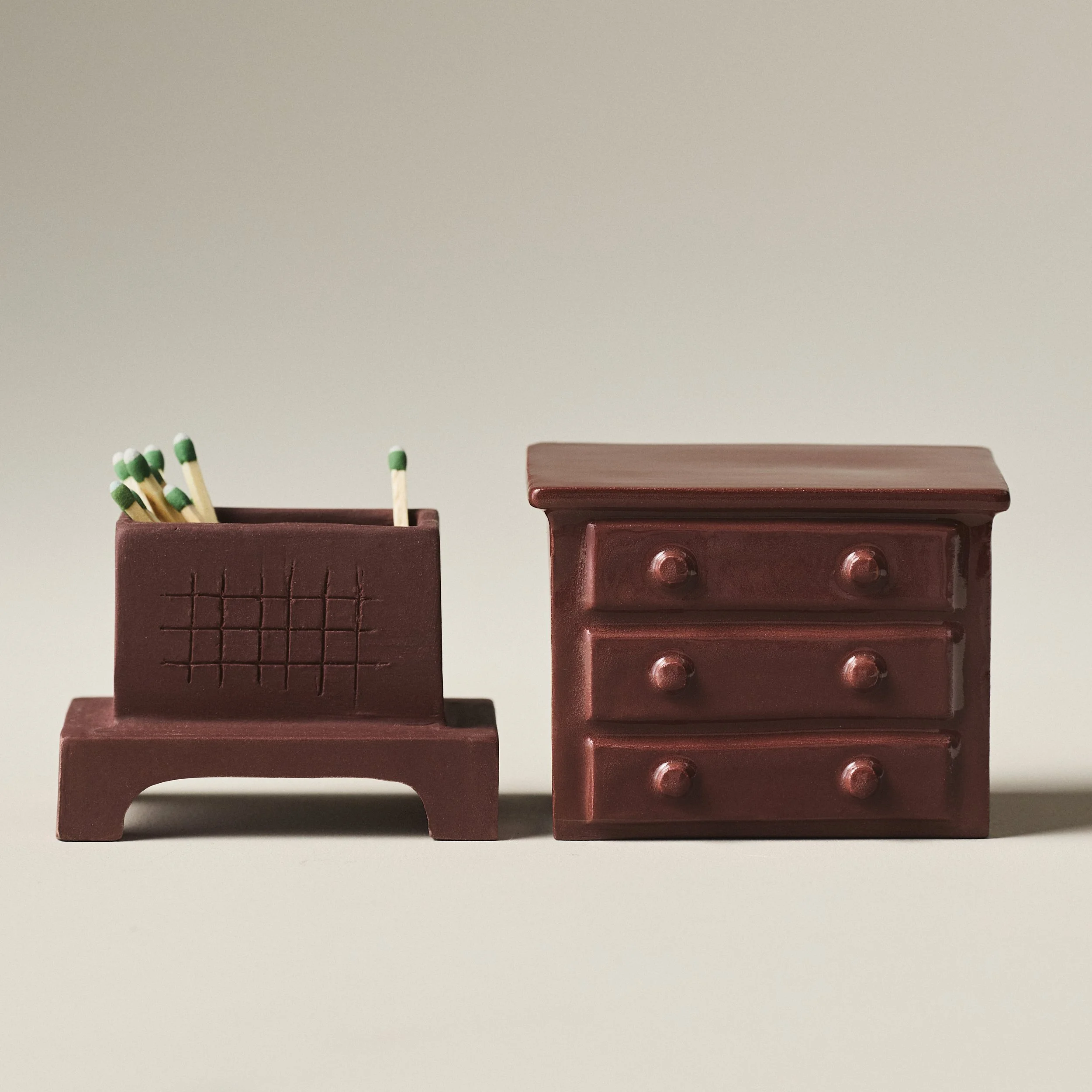 Two halves of the porcelain match strikers shown side by side