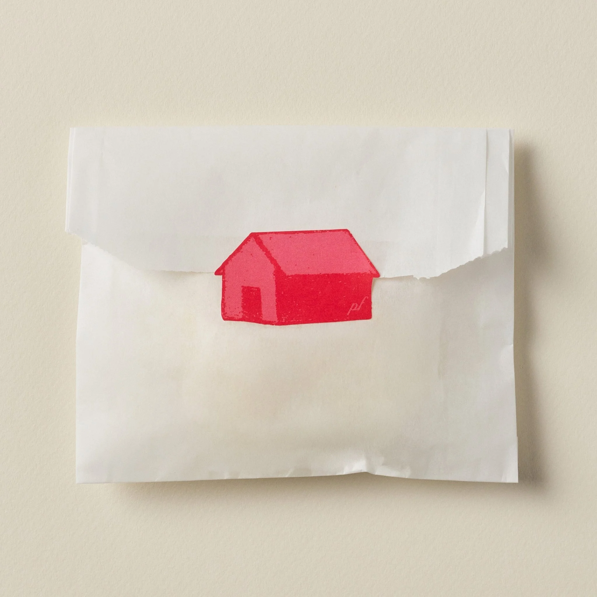 Top view of PetitFelts envelope packaging with red house seal centered on flap