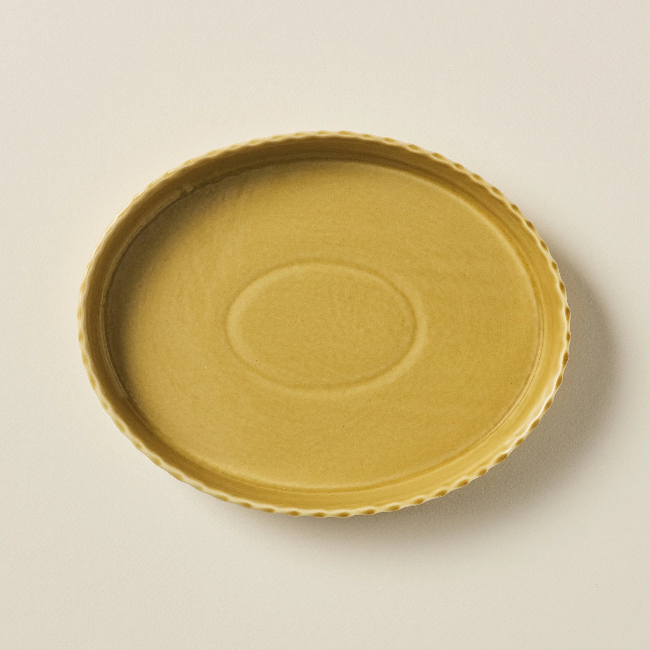 Overhead view of the PetitFelts Fennel ceramic platter's glazed interior