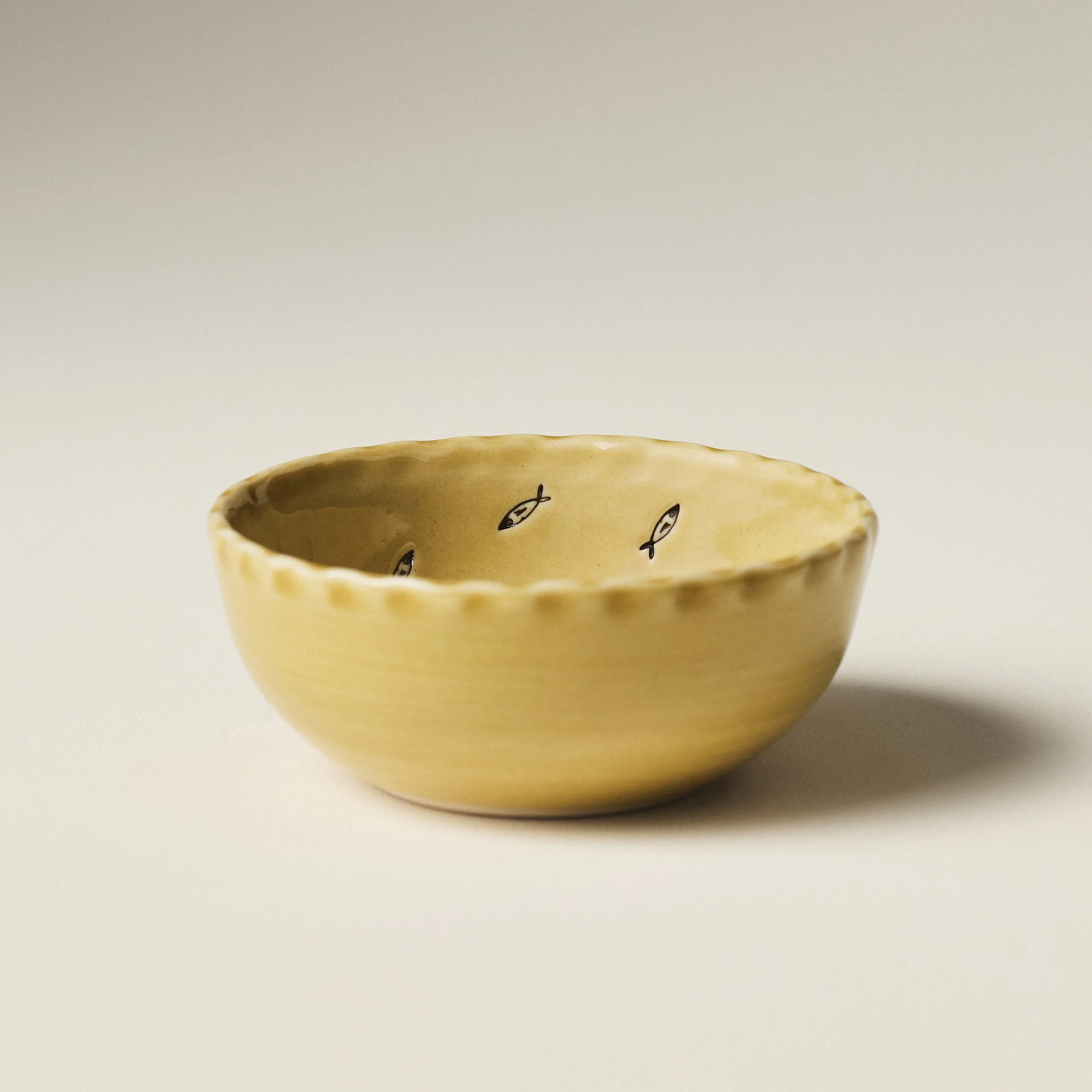 Front view of the PetitFelts Petite Bowl Julian stamp in Fennel glaze showing its scalloped rim