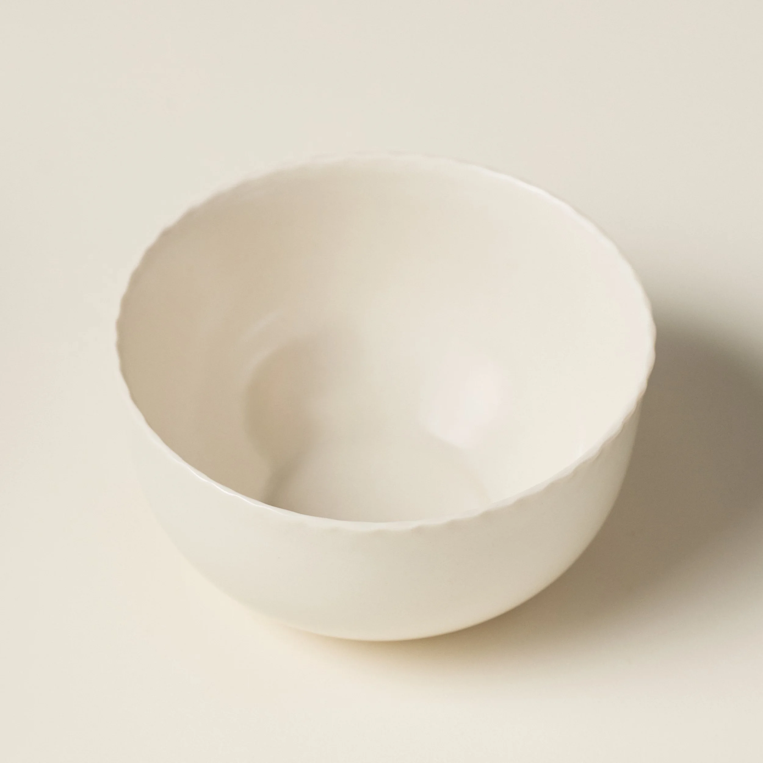 Overhead view of the PetitFelts Natural ceramic dinner bowl's glazed interior