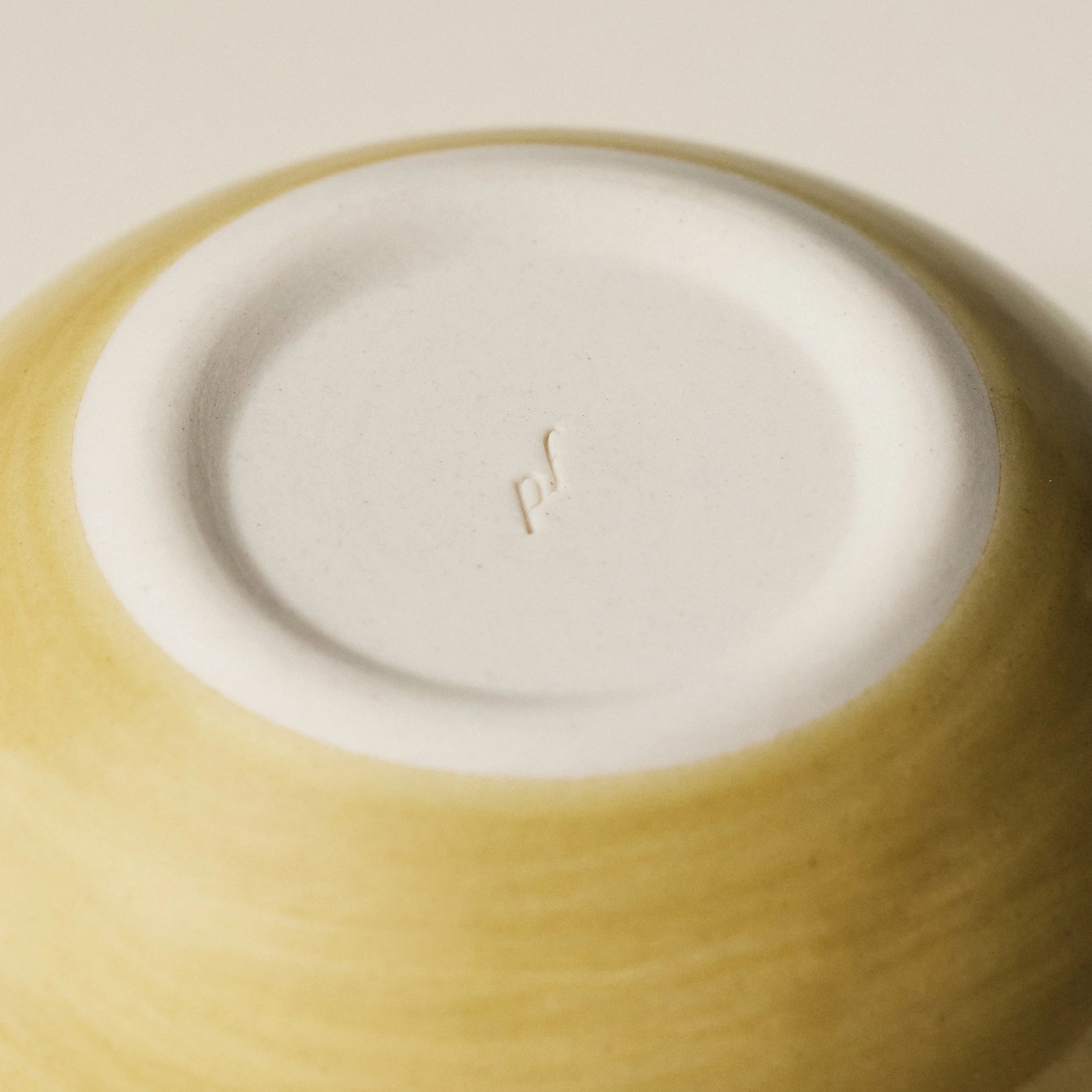 Underside detail of the PetitFelts Fennel small ceramic bowl showing the maker's mark