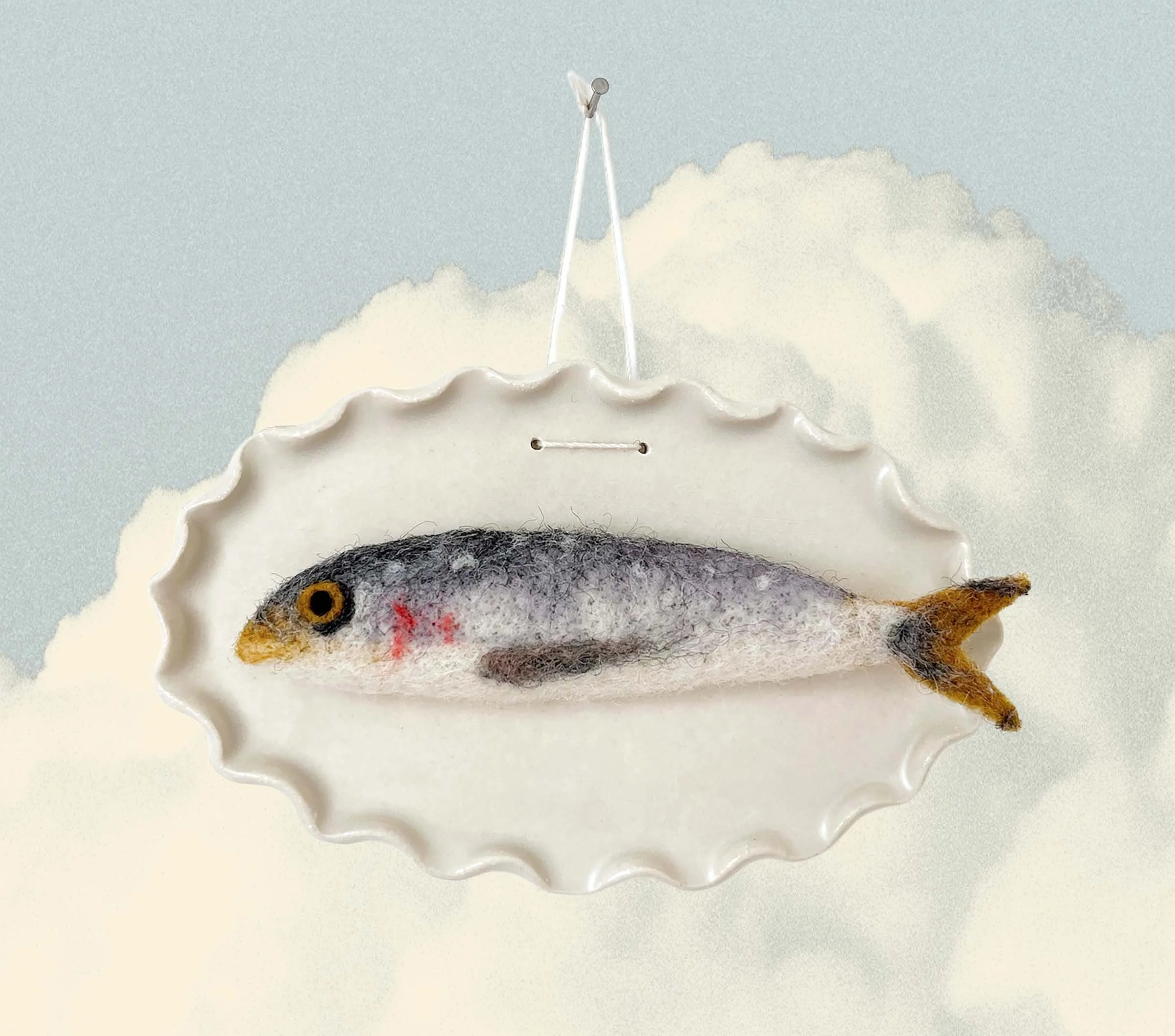 PetitFelts felted Julian on a ceramic plaque hung over clouds