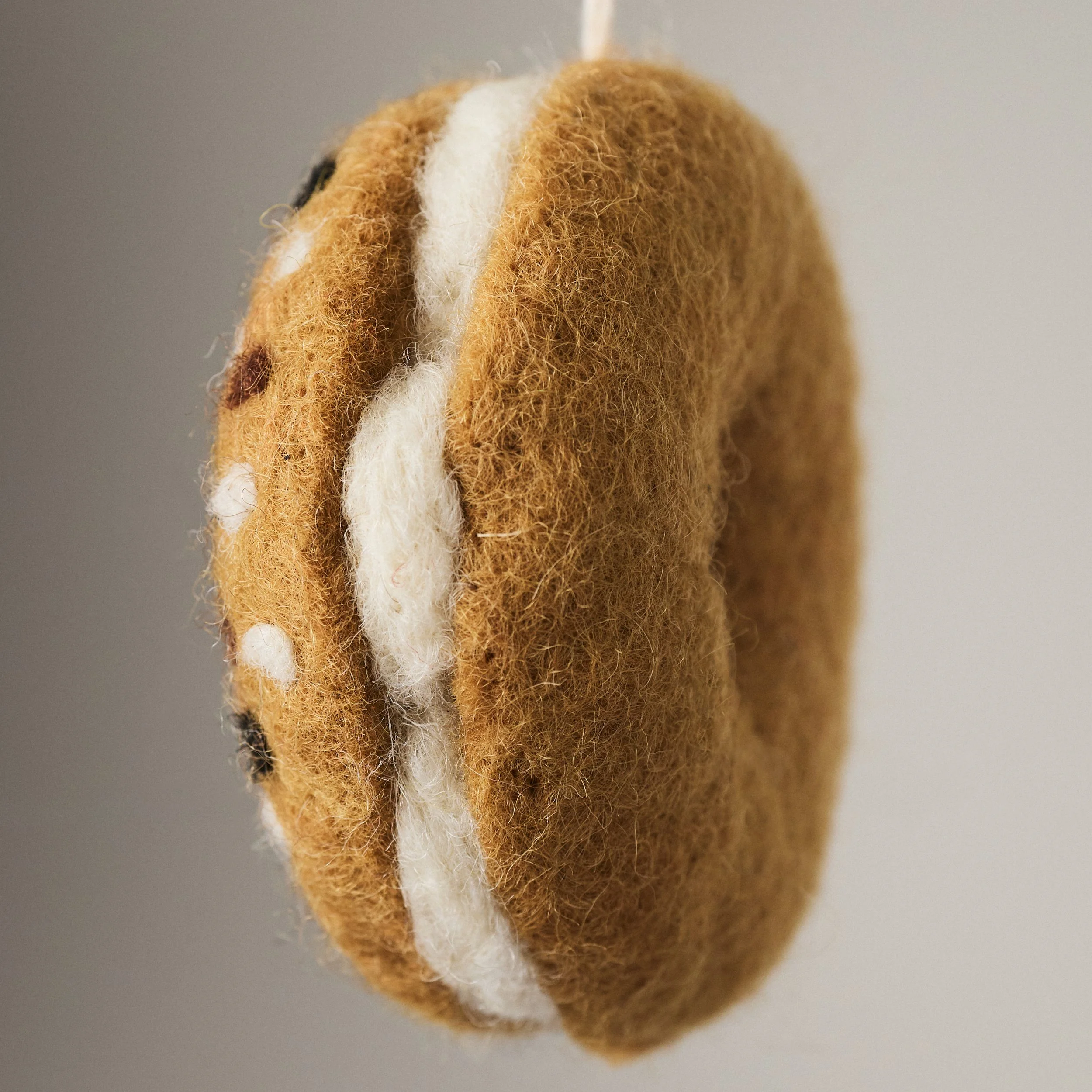 Everything Bagel needle felted 100% wool ornament. Halved with a cream cheese spread.