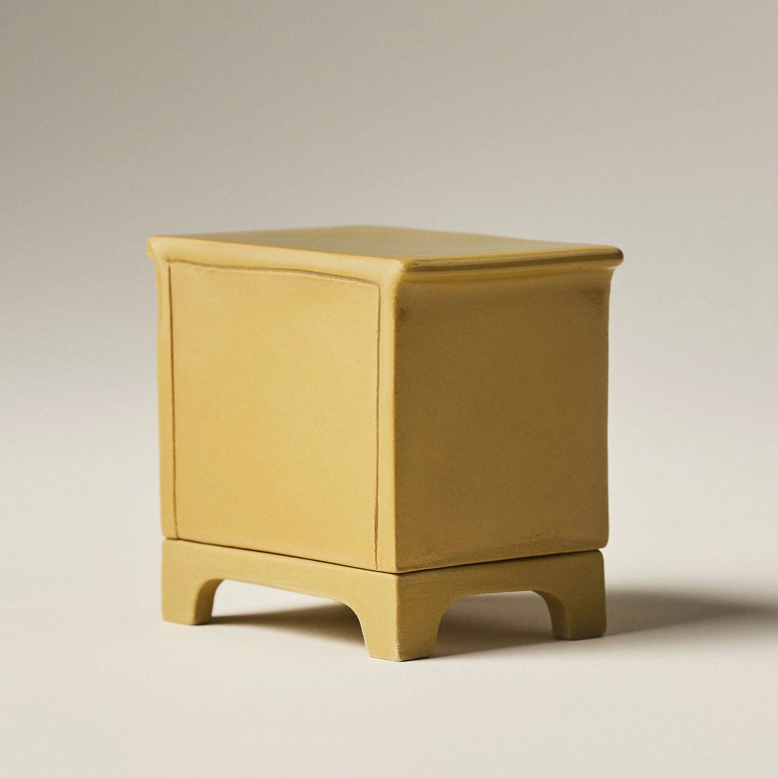 Angled view of the tinted porcelain dresser match holder in a Fennel clay