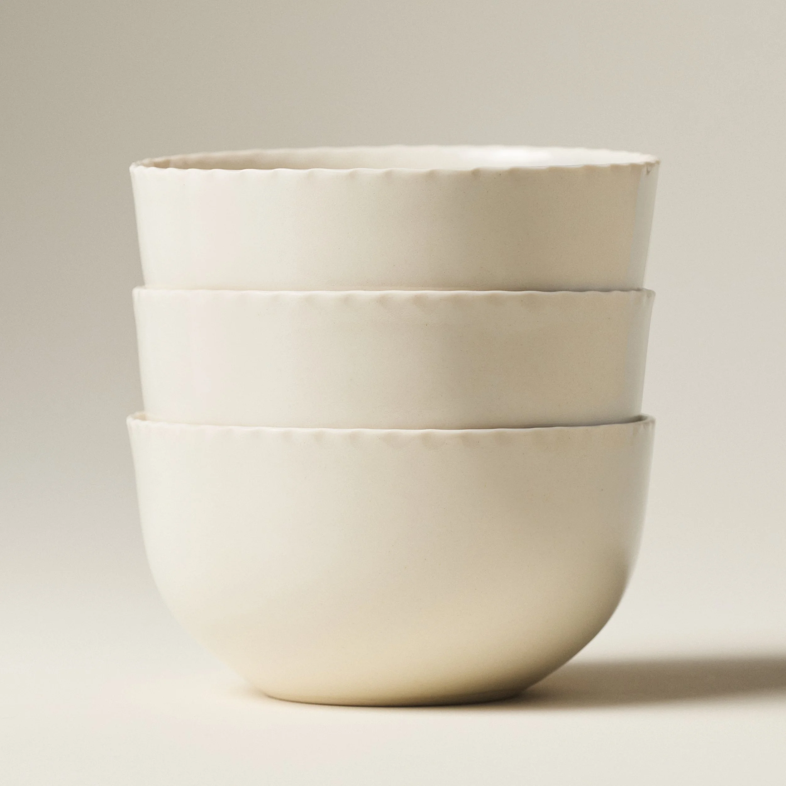 PetitFelts Natural ceramic dinner bowls stacked, showing rim detail and depth
