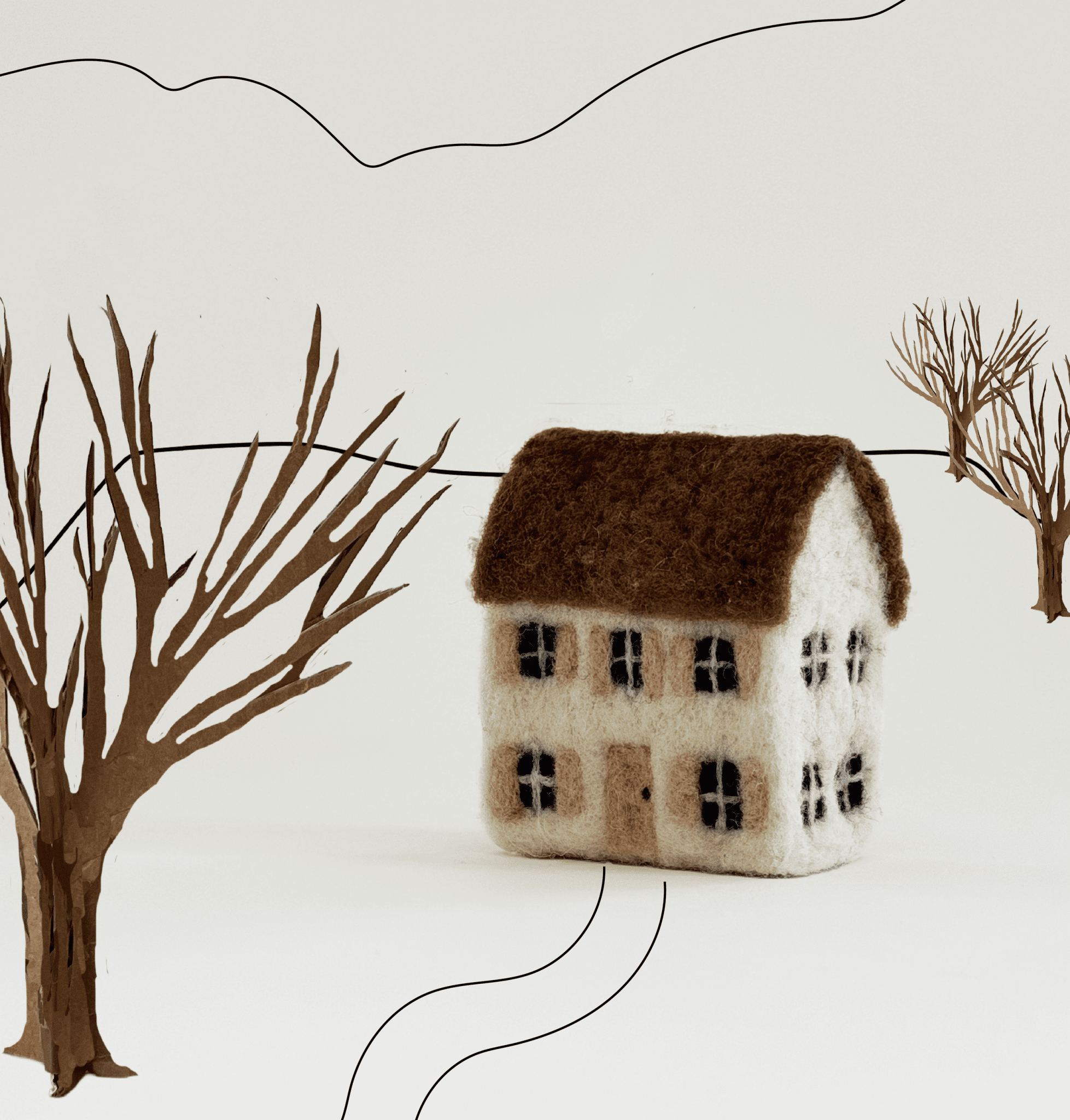 PetitFelts Needle Felted House amongst a background of line drawing and cardboard elements