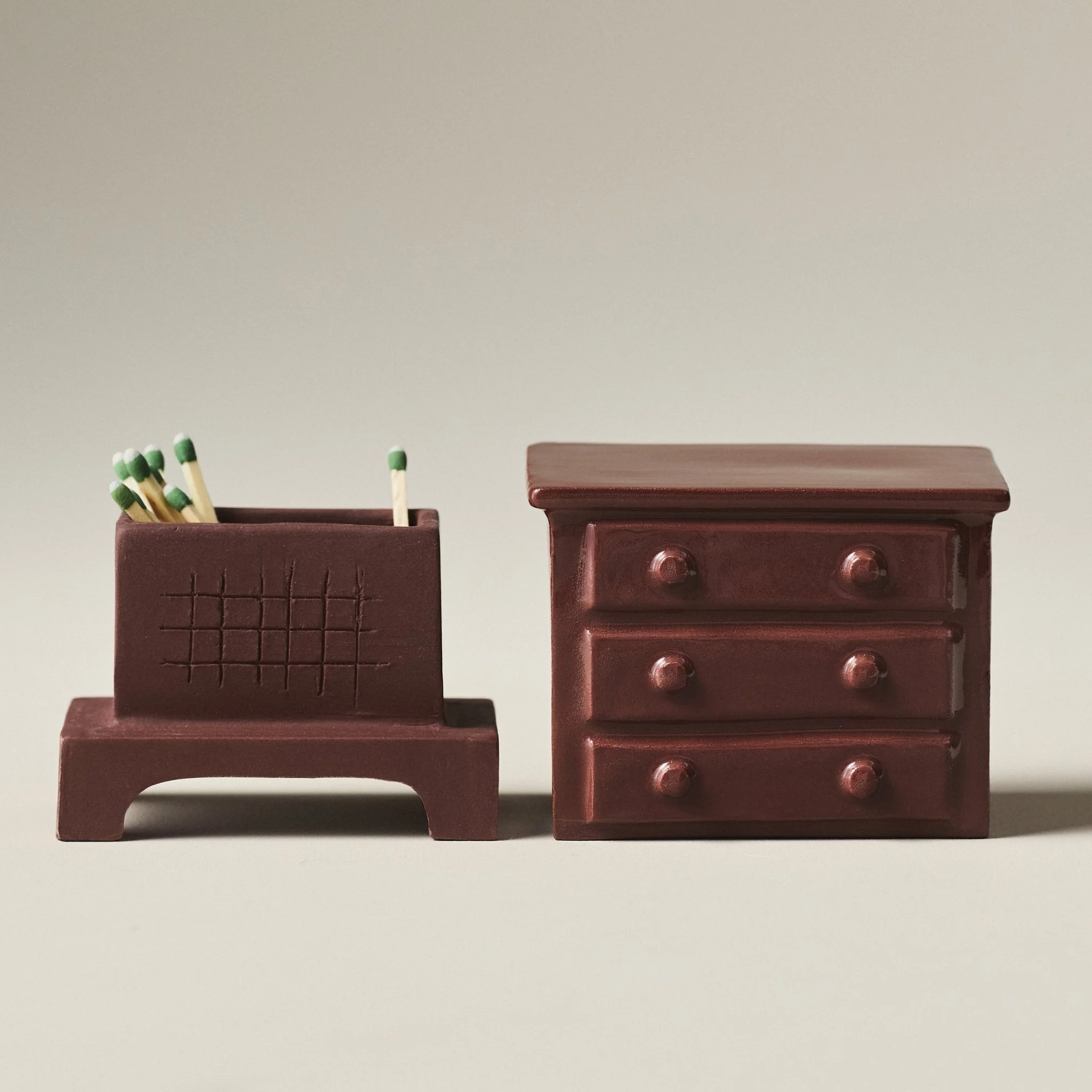 Two halves of the porcelain match strikers shown side by side