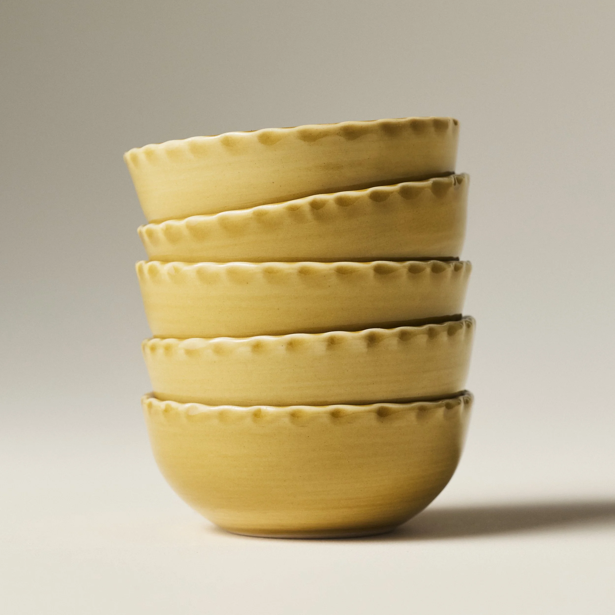 PetitFelts Fennel yellow ceramic bowls stacked, showing rim detail and depth