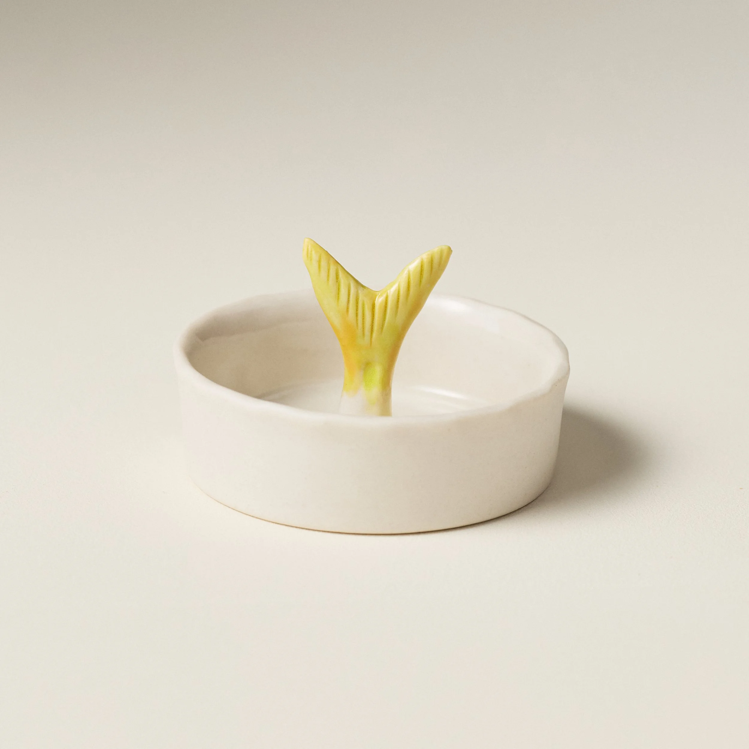 Angled view of the PetitFelts Julian Tail Moonflower ceramic salt dish interior