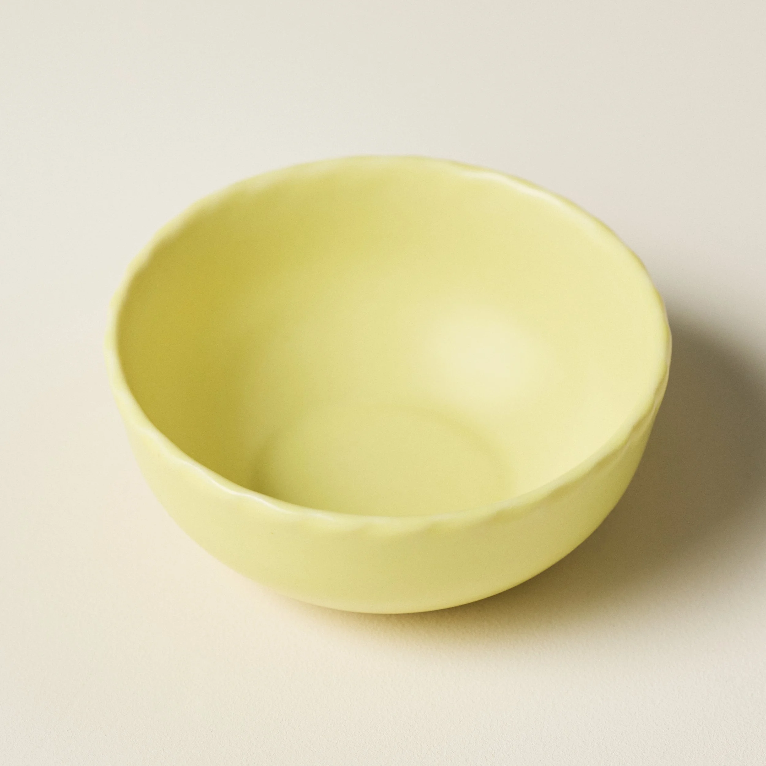 Overhead view of the PetitFelts Custard small ceramic bowl's glazed interior
