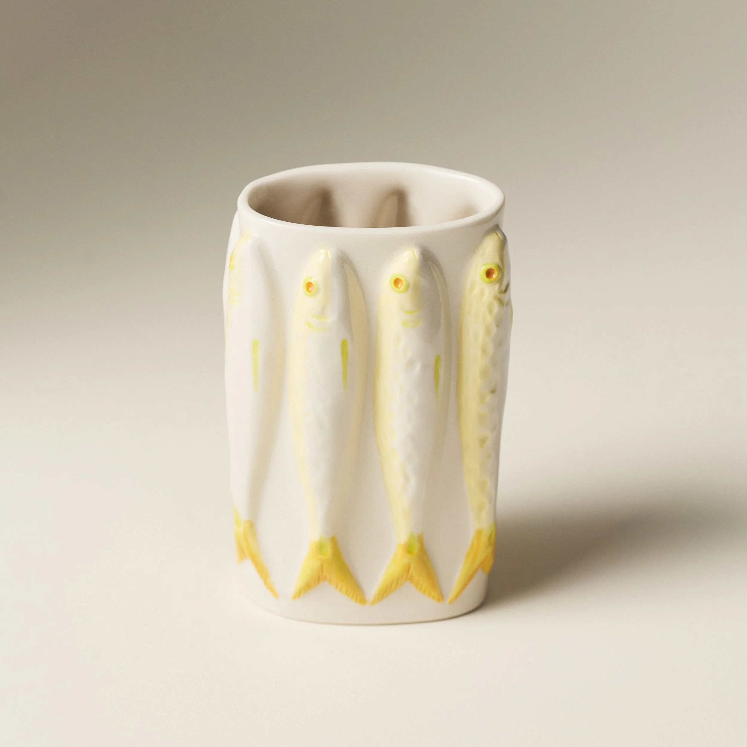 A shot from above of Julianware Moonflower vase featuring sardines in yellow tones and chartruese