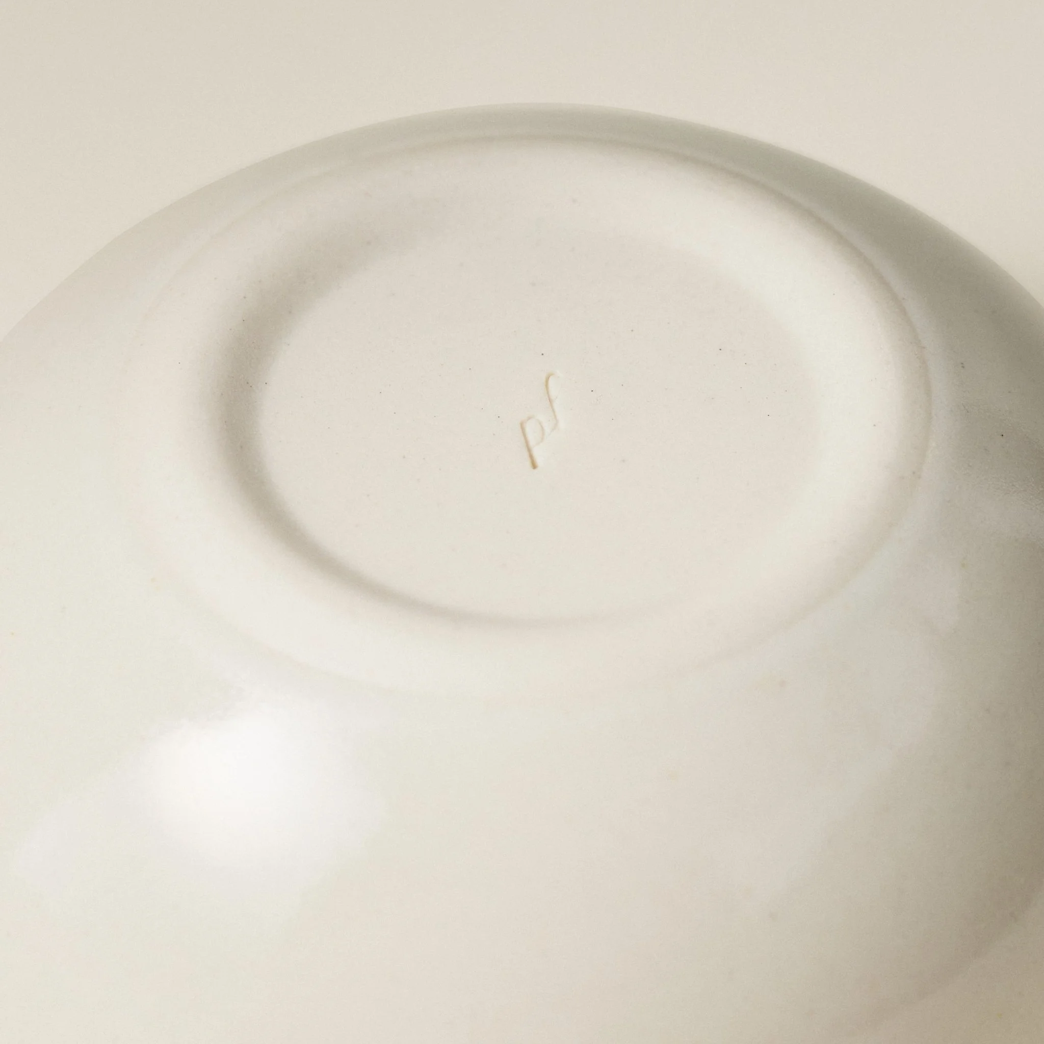 Underside detail of the PetitFelts Petite Bowl Julian stamp showing the maker's mark