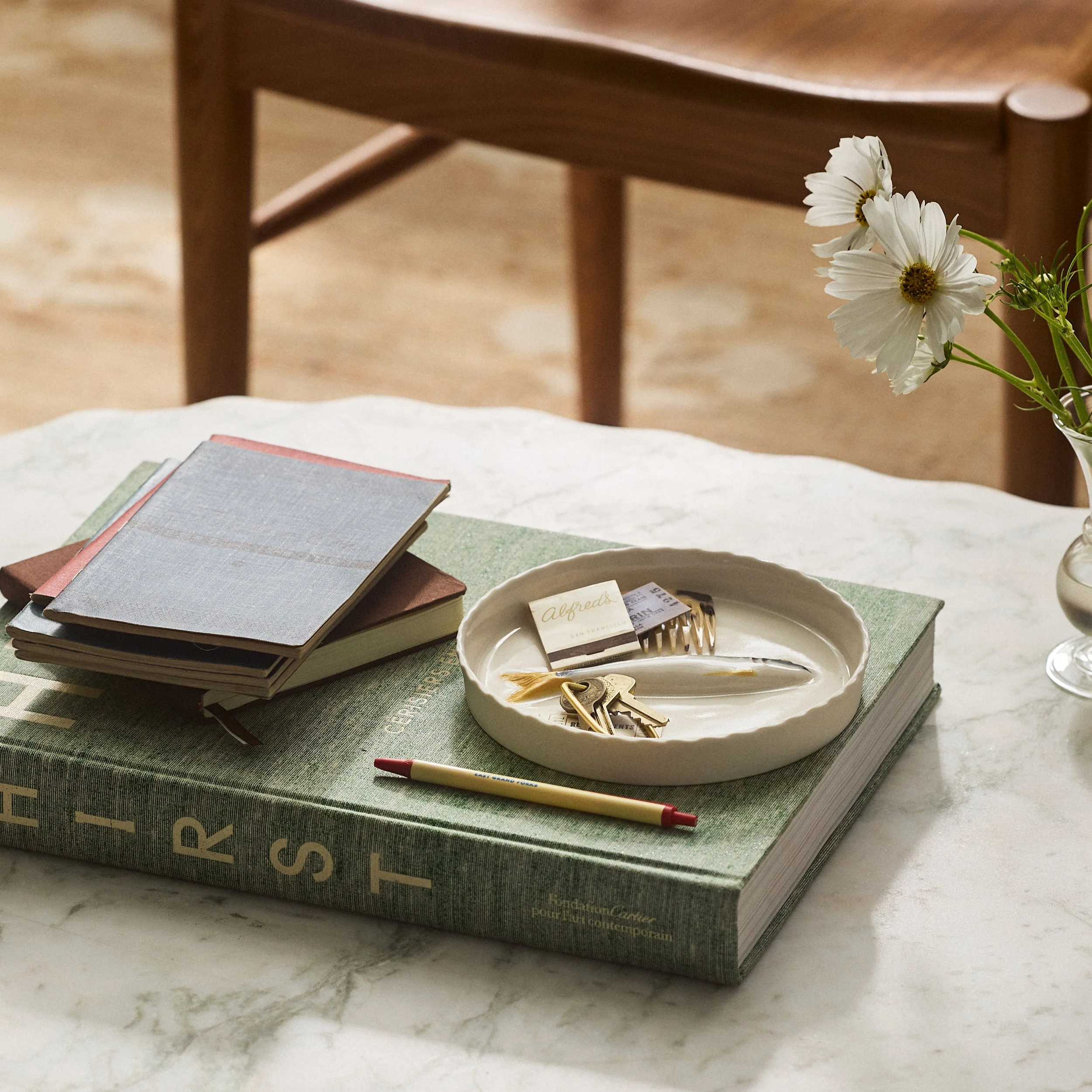 PetitFelts Little Julian ceramic jewelry tray styled on stacked books