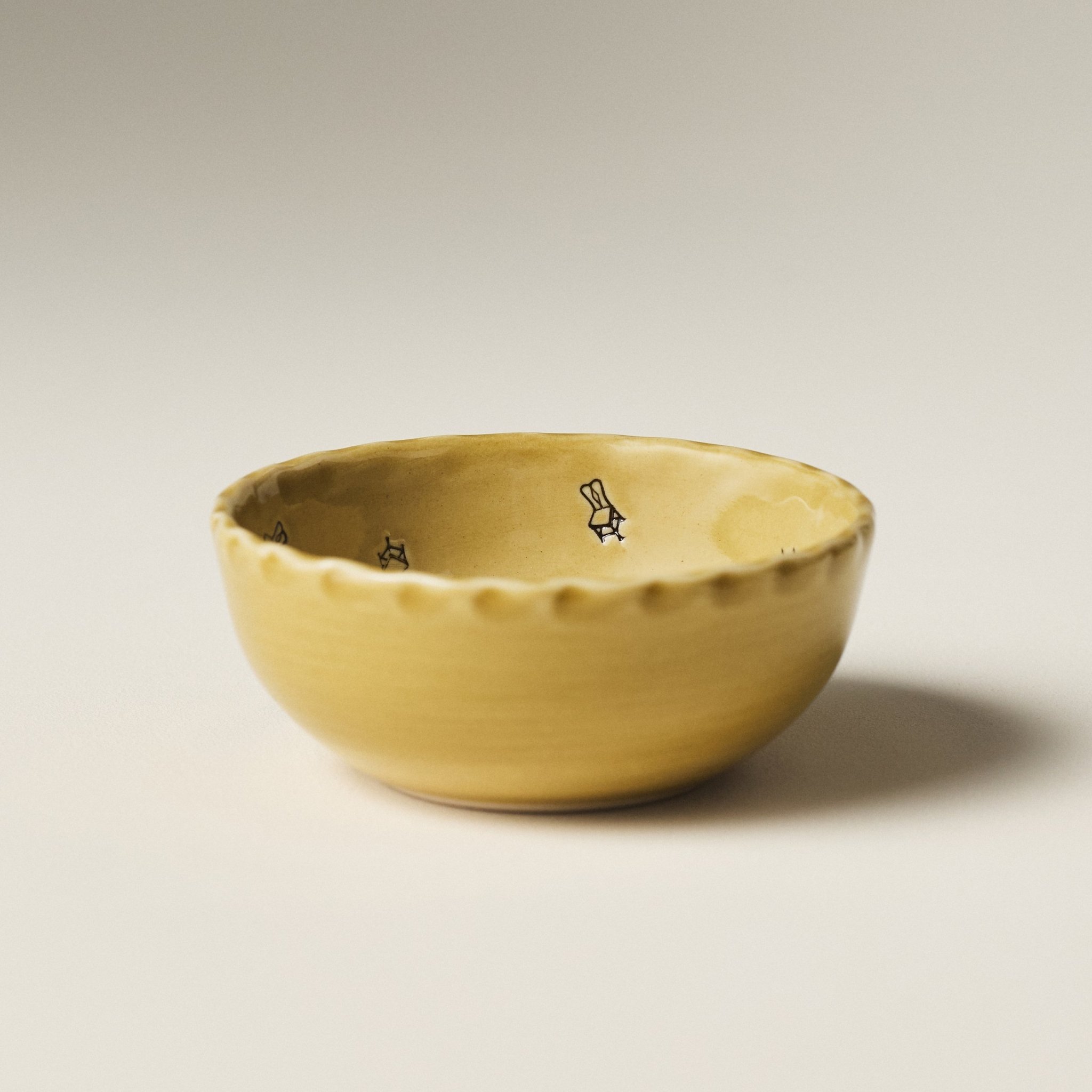 Front view of the PetitFelts Petite Bowl in Fennel glaze showing its scalloped rim