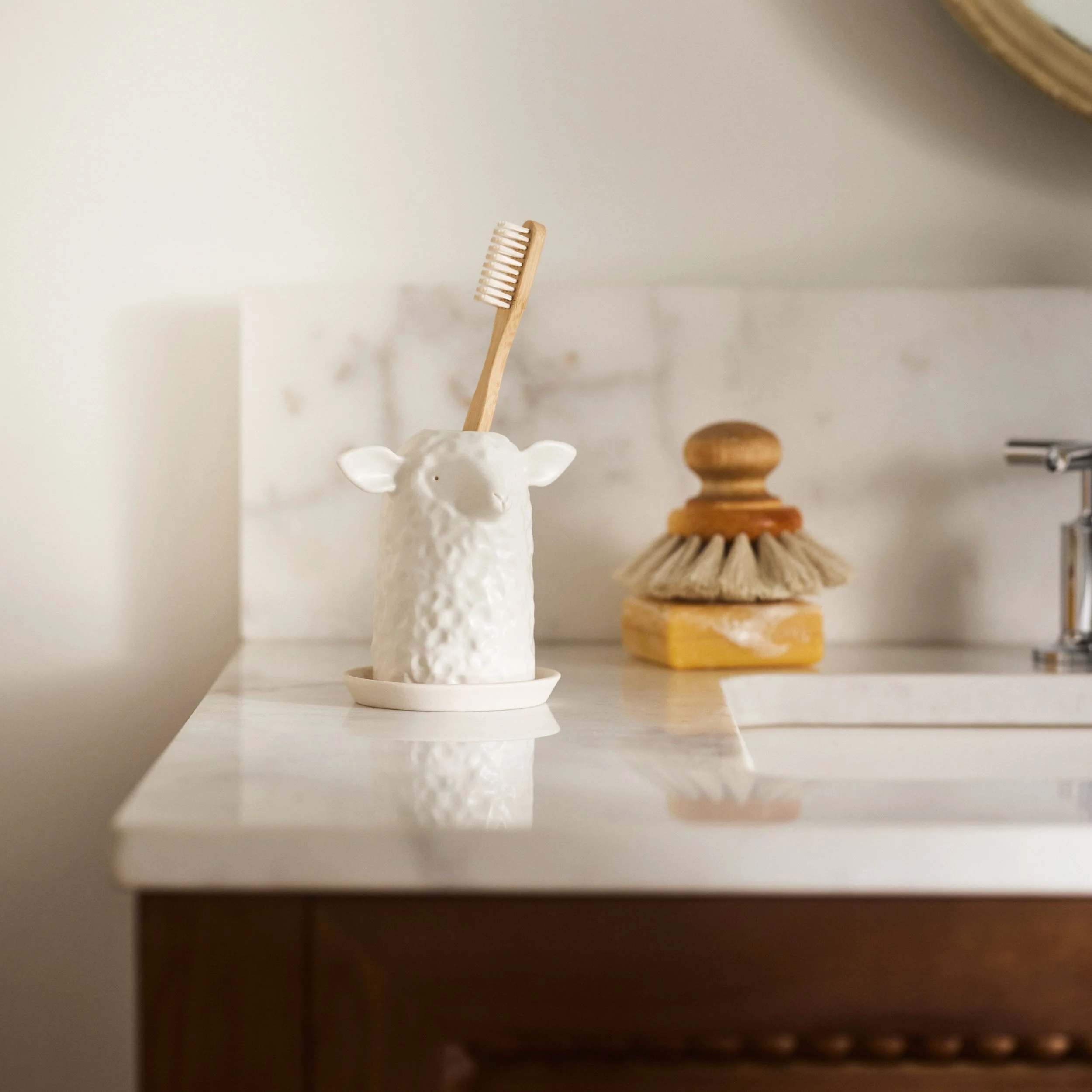 PetitFelts Herschel toothbrush holder styled on a bathroom vanity with a soap brush