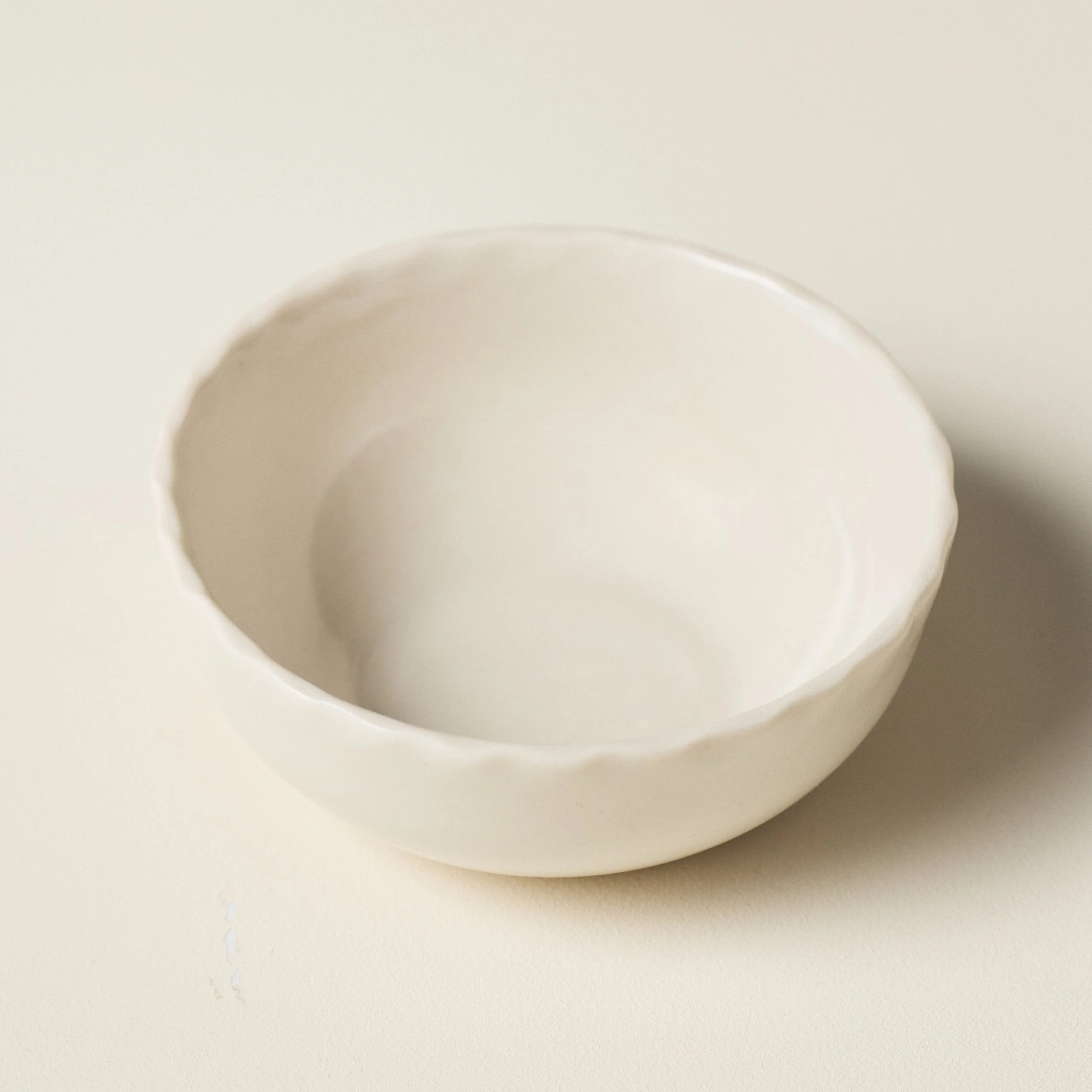 Overhead view of the PetitFelts Natural small ceramic bowl's glazed interior