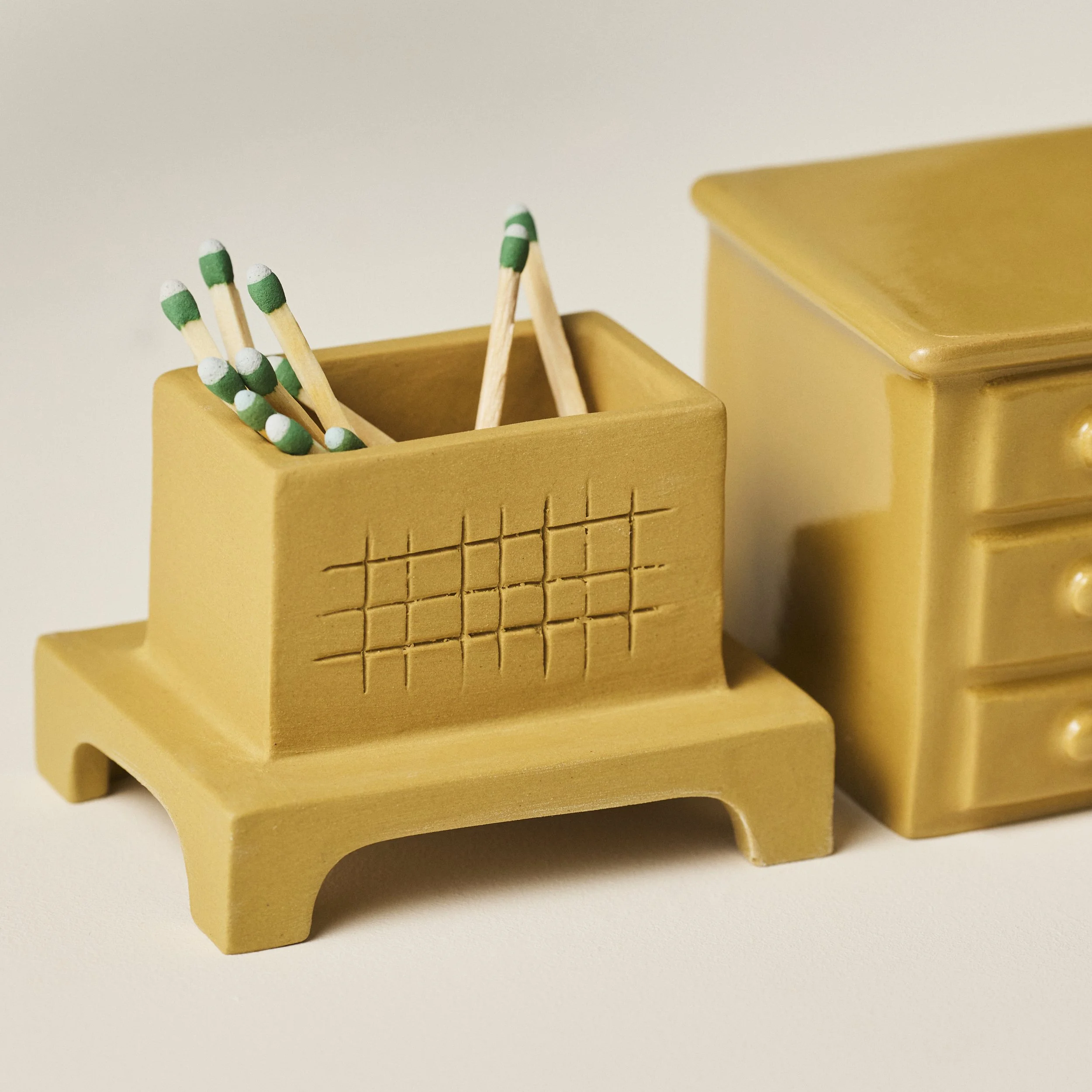 PetitFelts match holder with lid removed, showing matches stored inside the base