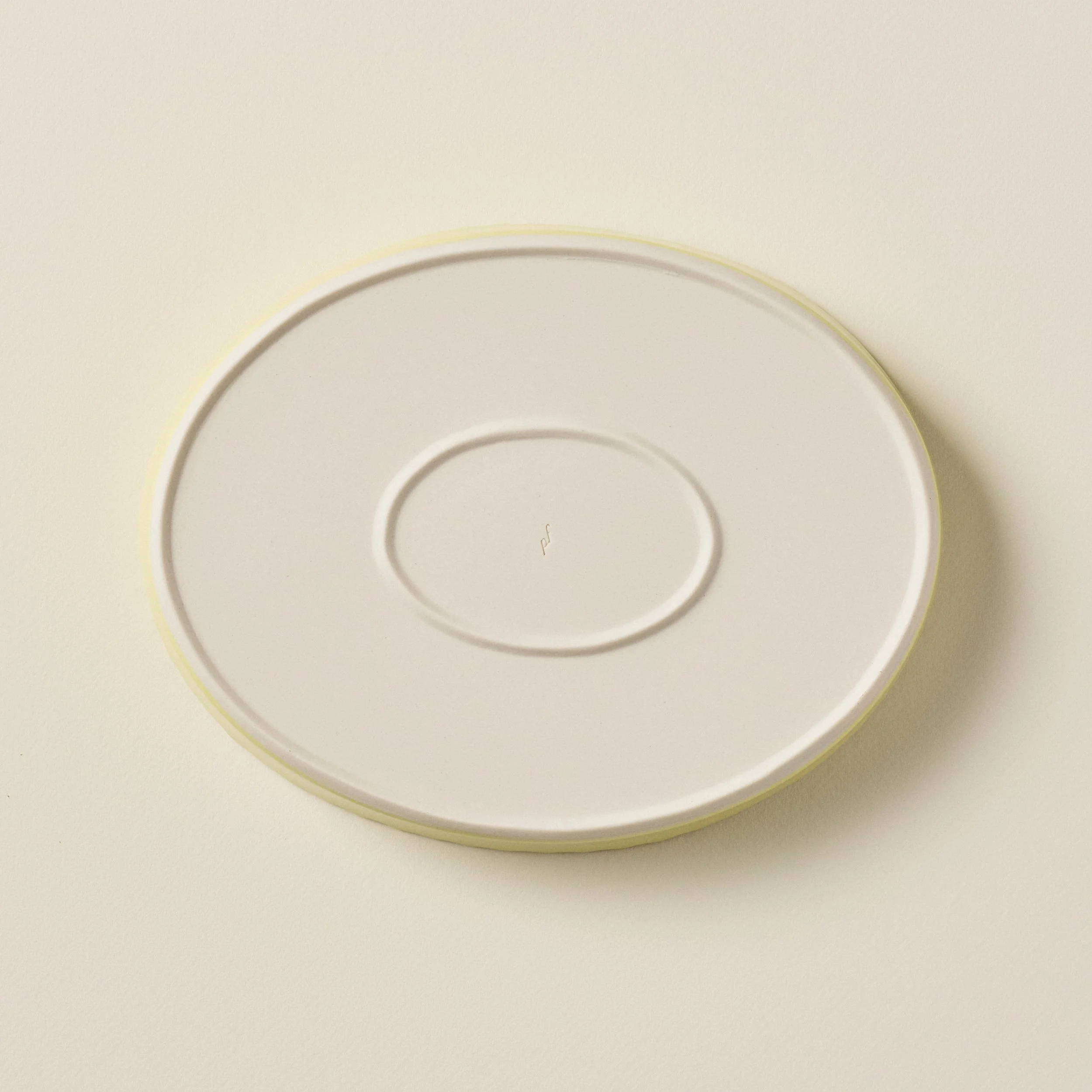 Overhead view of PetitFelts Custard ceramic platter foot