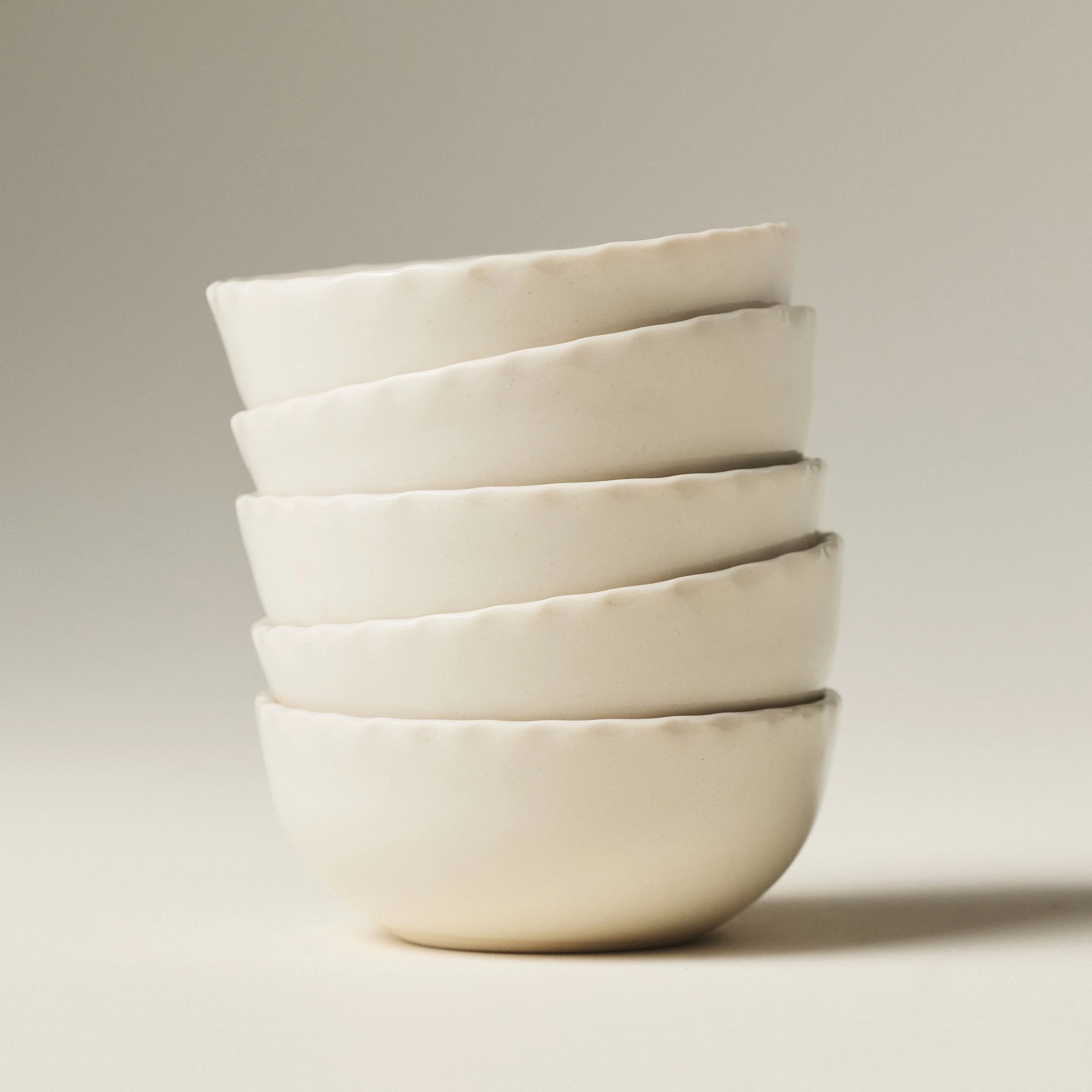 PetitFelts Natural small ceramic bowls stacked, showing rim detail and depth