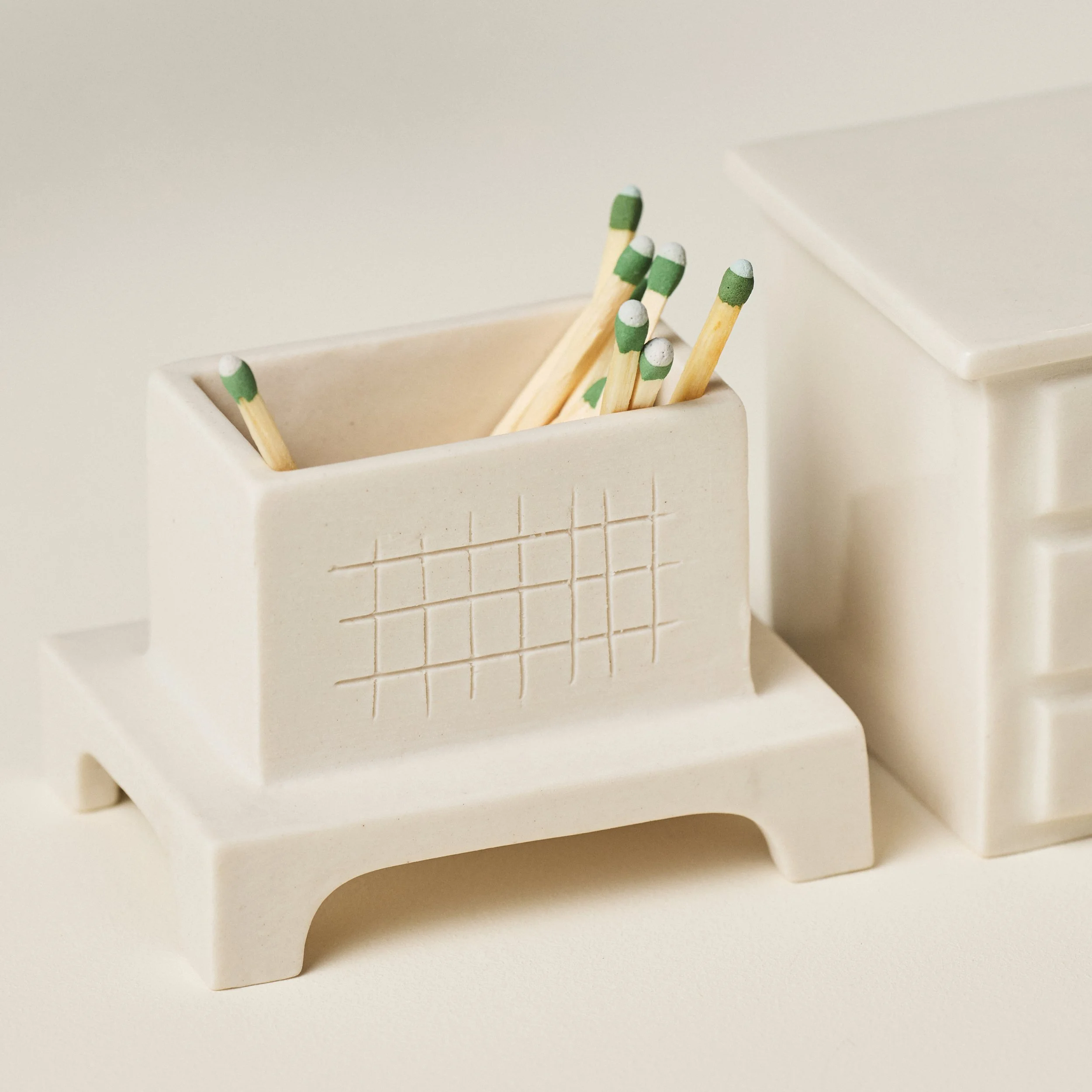 Detail of the textured striking surface inside an open porcelain match striker