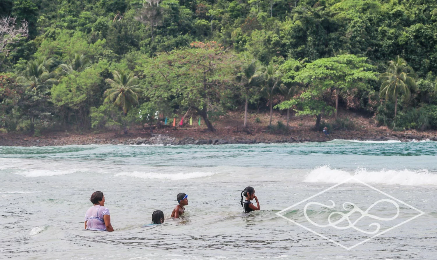 Local Family playing in the ocean