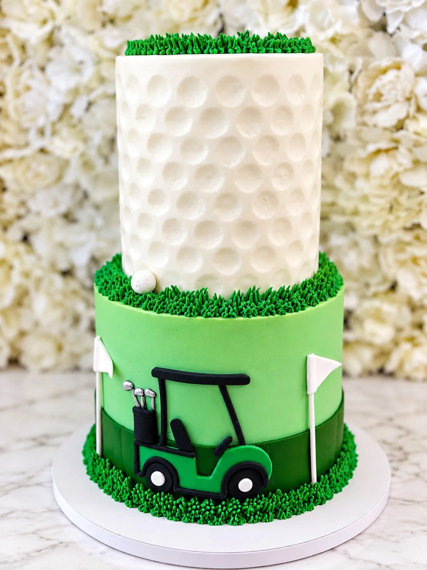 On this day 
September 12, 2026

⛳️💚 A hole-in-ONE celebration! 💚

This custom two-tier golf cake features a golf ball-inspired top tier, hand-piped buttercream grass, a golf course design, and handcrafted details including the cutest little golf c